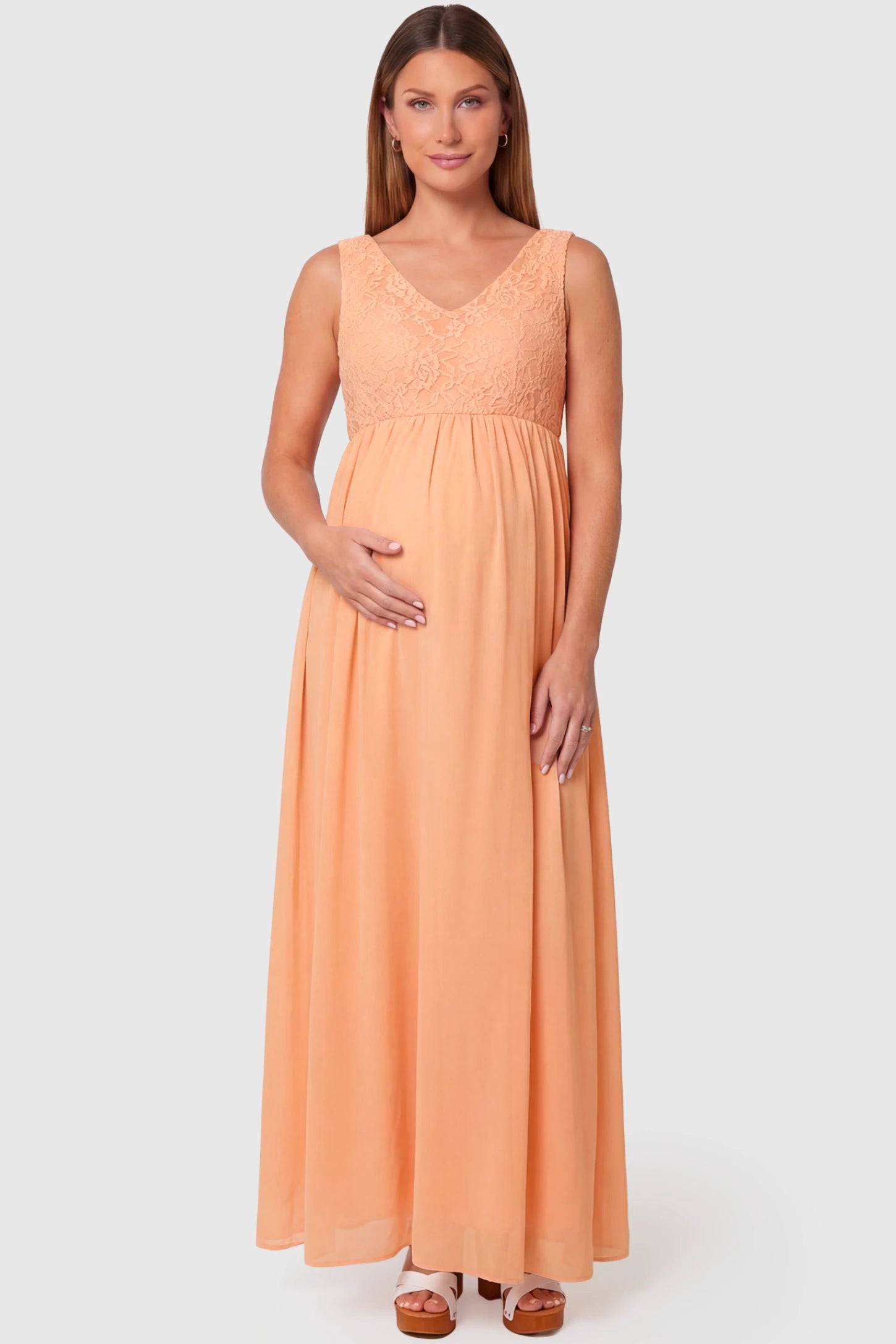 Lace Empire Waist Maternity Maxi Dress Lace Empire Waist Maternity Maxi Dress in pink featuring V-neckline and flowing relaxed fit on pregnant model.