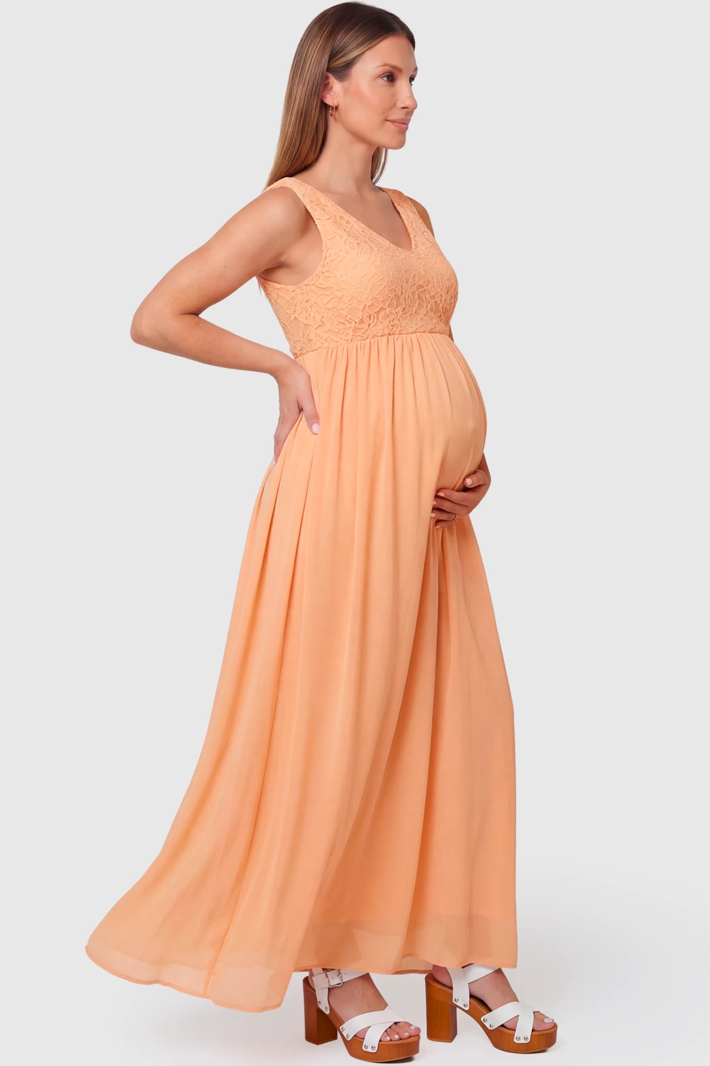 Lace Empire Waist Maternity Maxi Dress Lace Empire Waist Maternity Maxi Dress in pink featuring V-neckline and flowing relaxed fit on pregnant model.