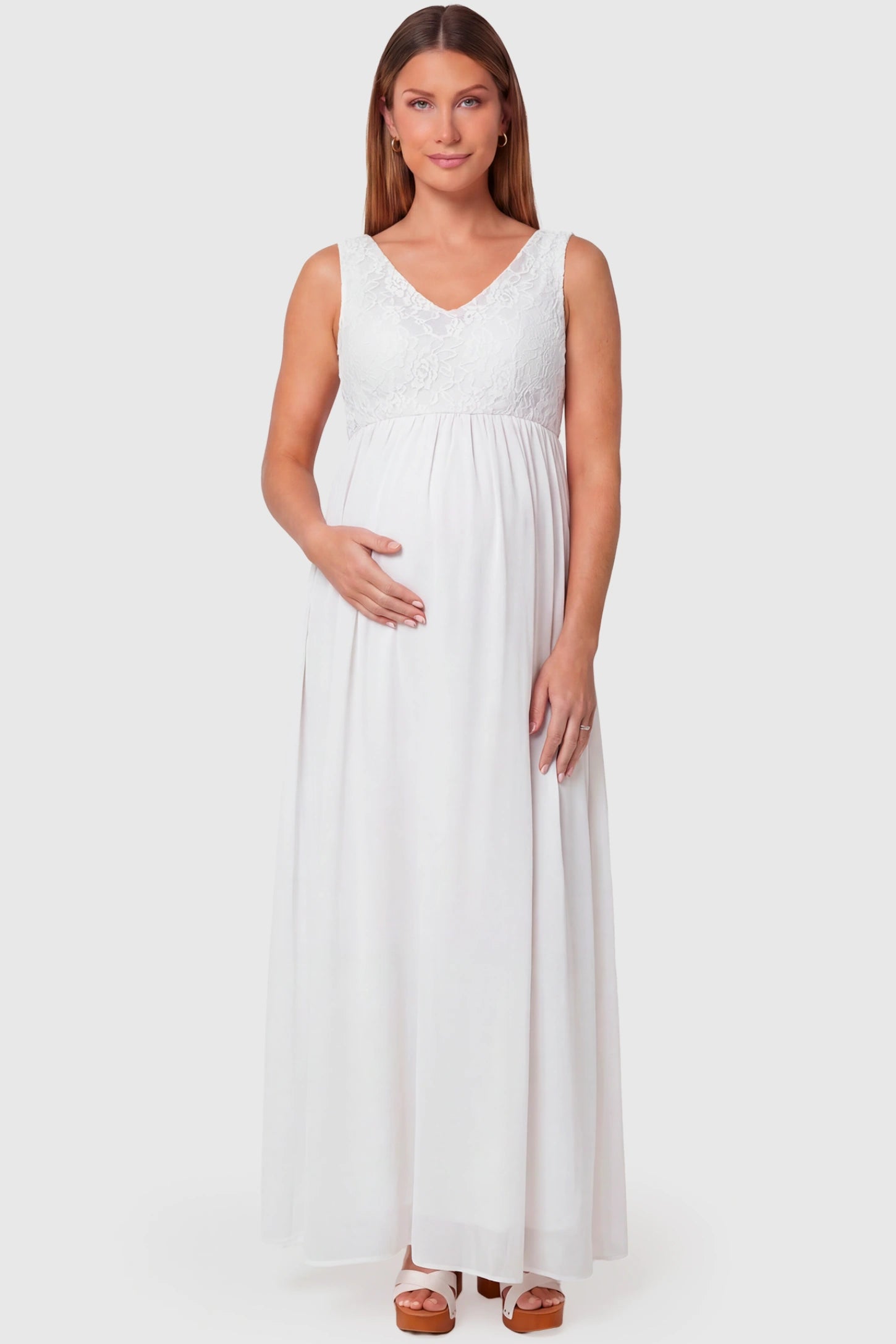 Lace Empire Waist Maternity Maxi Dress Lace Empire Waist Maternity Maxi Dress in white featuring V-neckline and flowing relaxed fit on pregnant model.