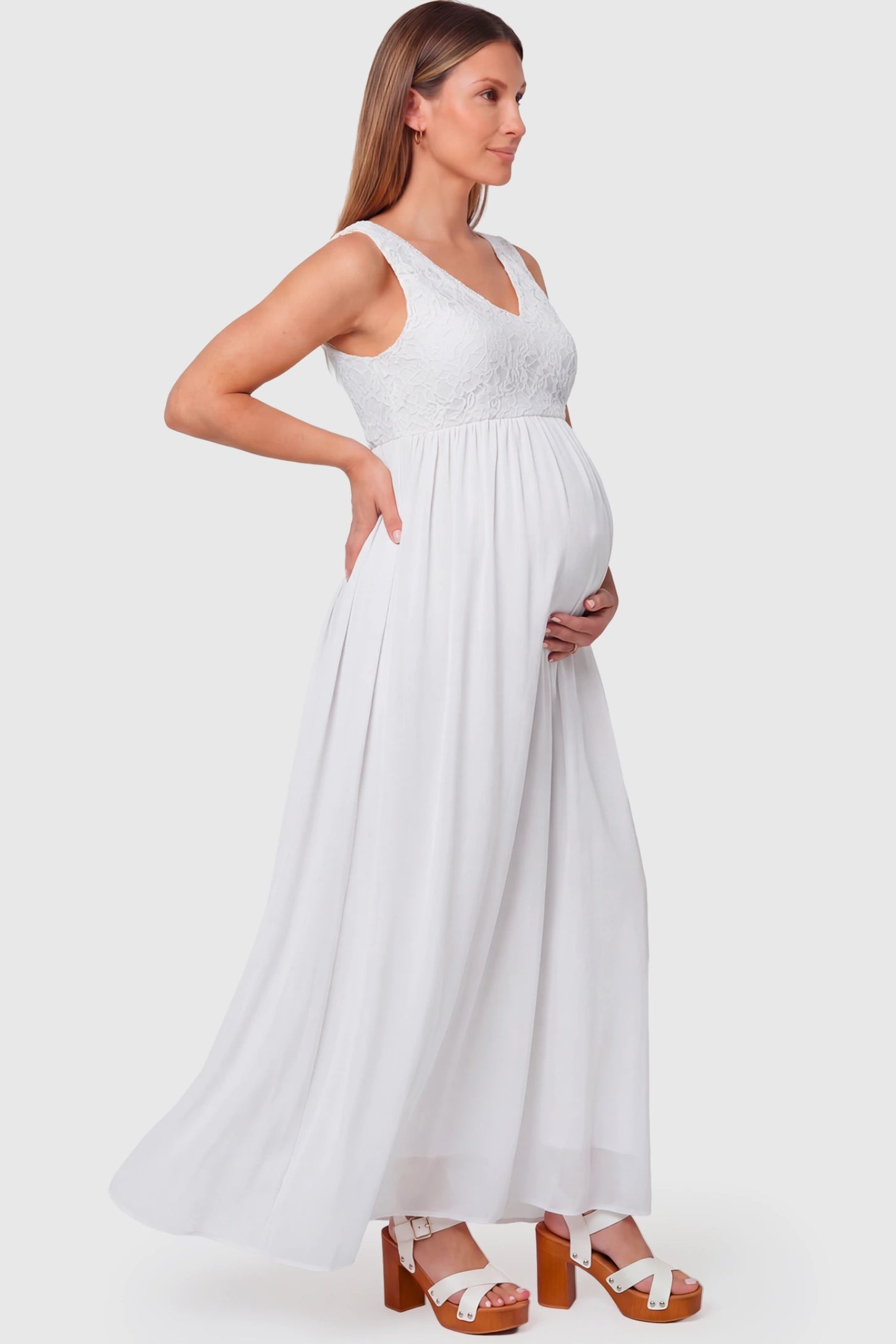 Lace Empire Waist Maternity Maxi Dress Lace Empire Waist Maternity Maxi Dress in white featuring V-neckline and flowing relaxed fit on pregnant model.