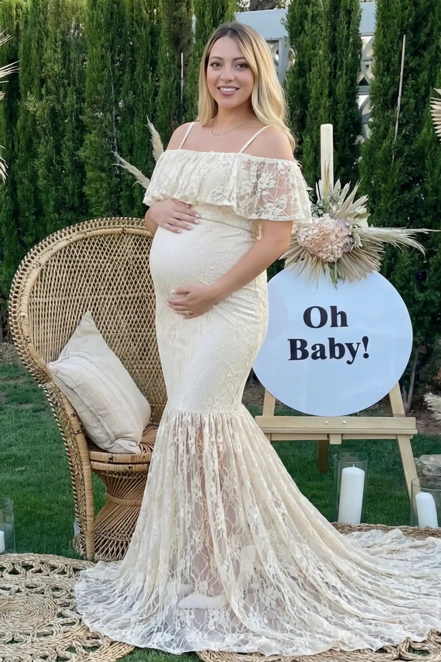 Lace off-shoulder maternity gown in apricot featuring ruffle neckline, mermaid silhouette, and extended lace train on pregnant model.