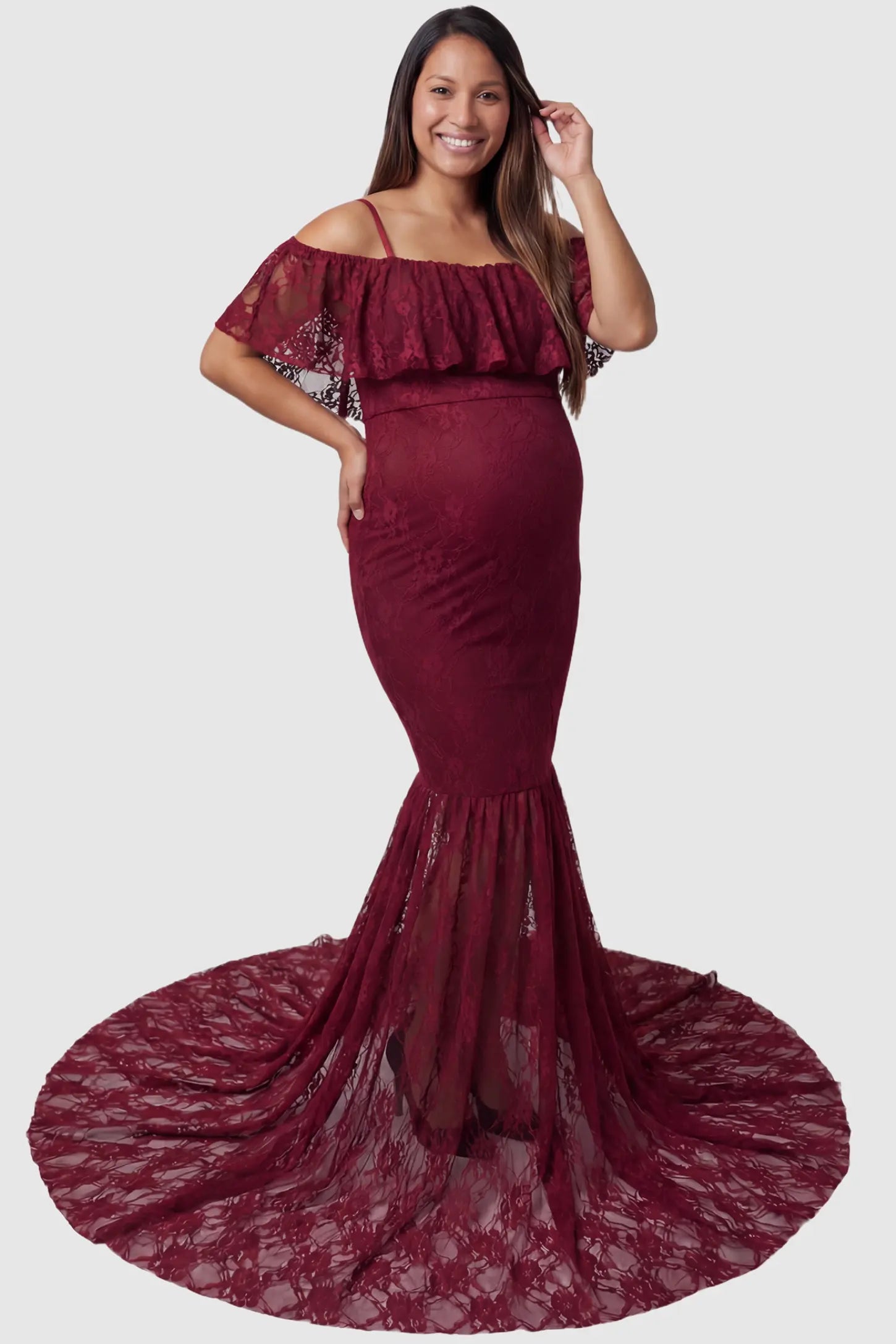 Lace Off-Shoulder Ruffle Short Sleeve Maternity Dress Lace off-shoulder maternity gown in burgundy featuring ruffle neckline, mermaid silhouette, and extended lace train on pregnant model. front view