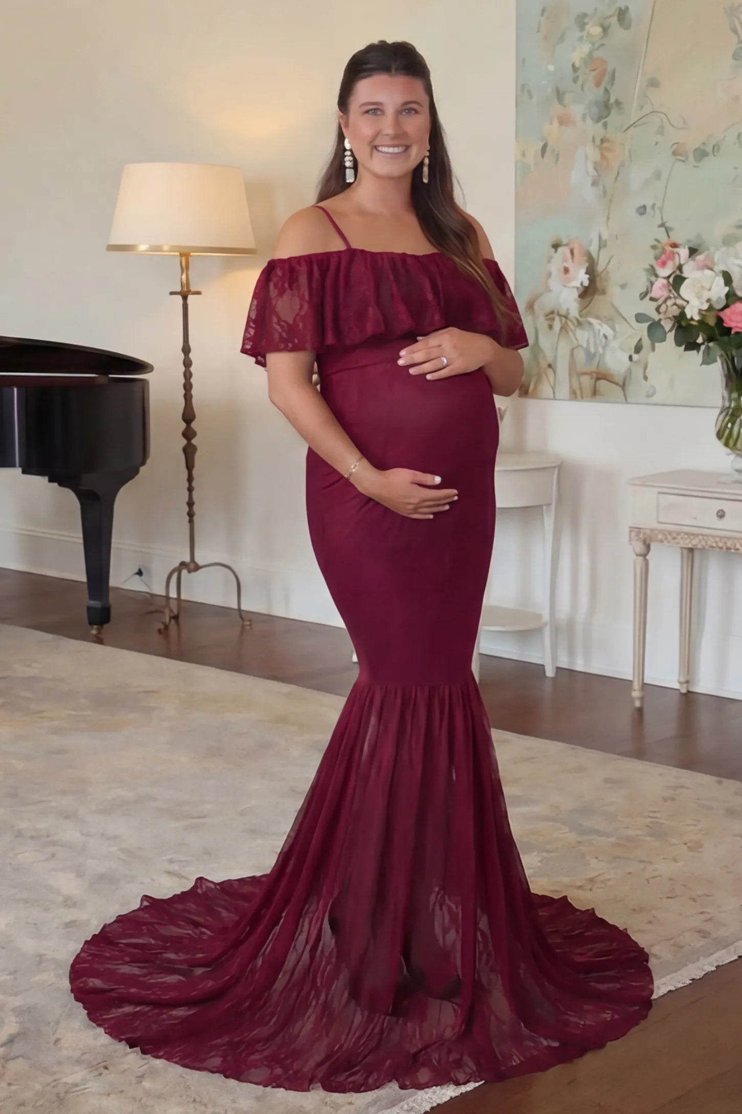Lace Off-Shoulder Ruffle Short Sleeve Maternity Dress Lace off-shoulder maternity gown in burgundy featuring ruffle neckline, mermaid silhouette, and extended lace train on pregnant model.