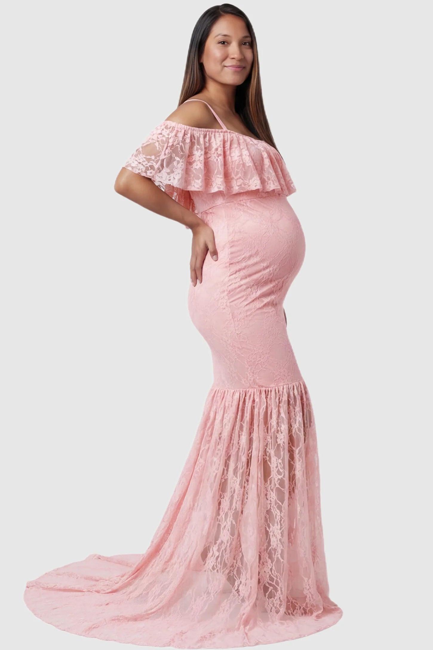 Lace Off-Shoulder Ruffle Short Sleeve Maternity Dress Lace off-shoulder maternity gown in pink featuring ruffle neckline, mermaid silhouette, and extended lace train on pregnant model. side view