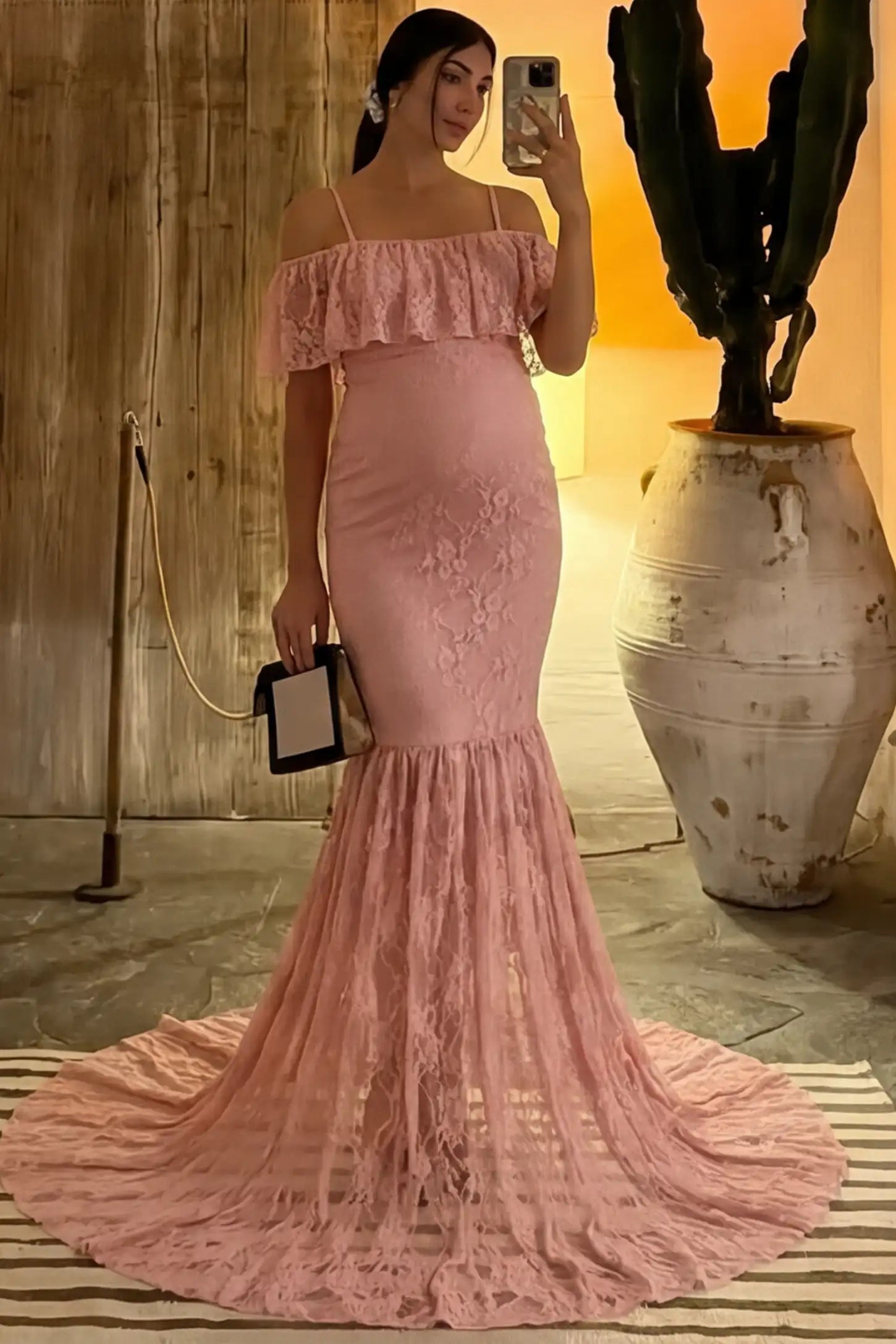Lace Off-Shoulder Ruffle Short Sleeve Maternity Dress Lace off-shoulder maternity gown in pink featuring ruffle neckline, mermaid silhouette, and extended lace train on pregnant model. 
