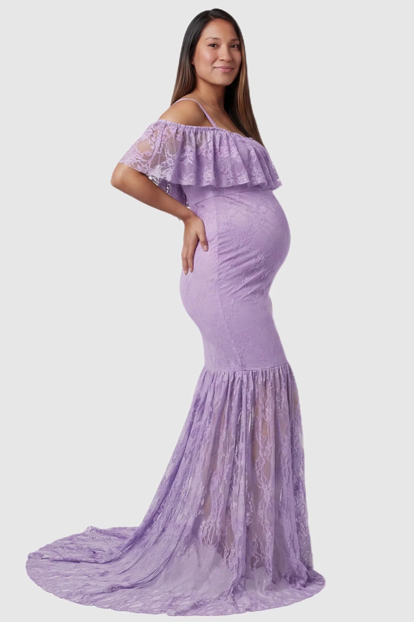 Lace Off-Shoulder Ruffle Short Sleeve Maternity Dress Lace off-shoulder maternity gown in purple featuring ruffle neckline, mermaid silhouette, and extended lace train on pregnant model. side view