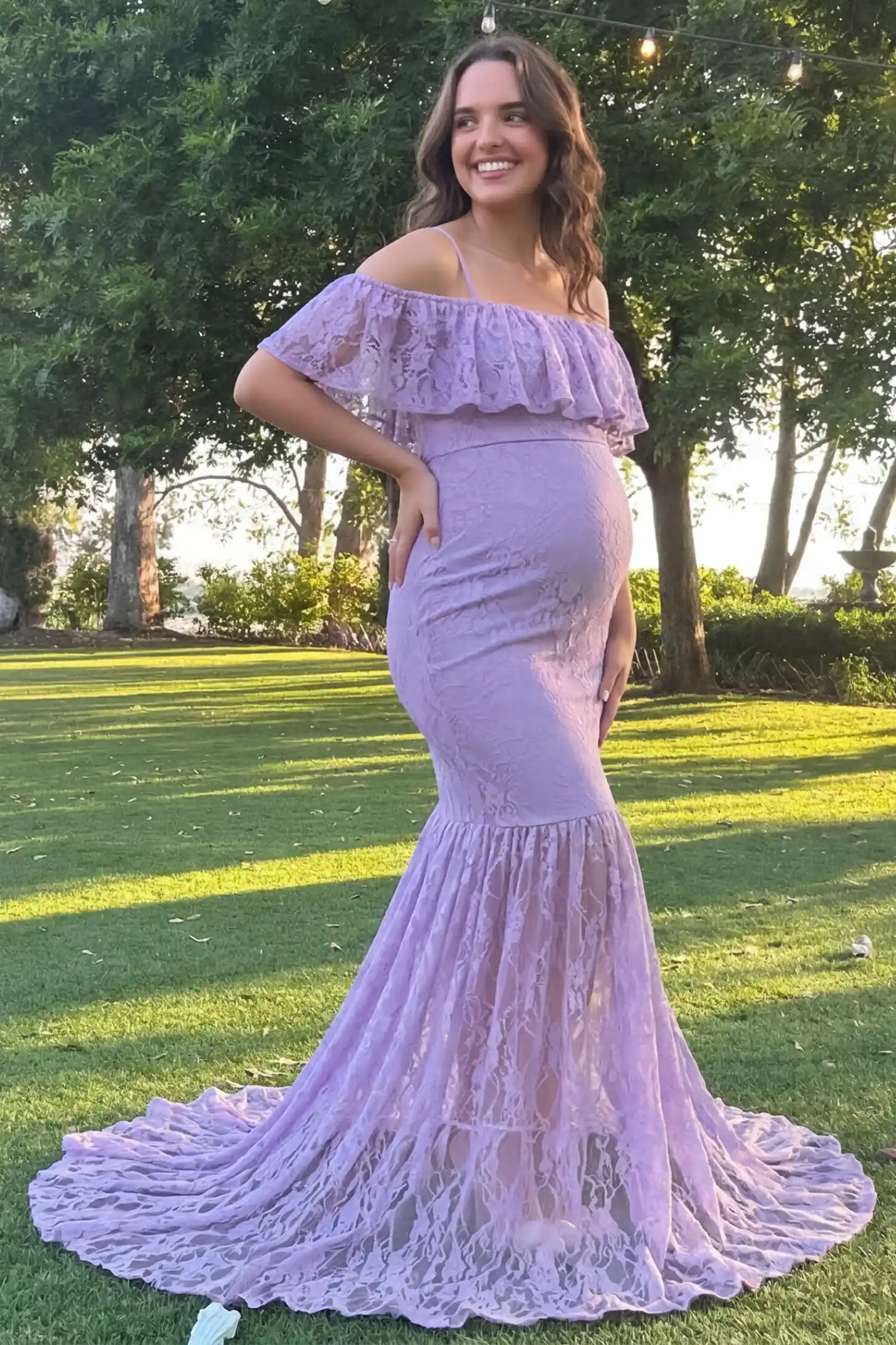Lace Off-Shoulder Ruffle Short Sleeve Maternity Dress Lace off-shoulder maternity gown in purple featuring ruffle neckline, mermaid silhouette, and extended lace train on pregnant model. 
