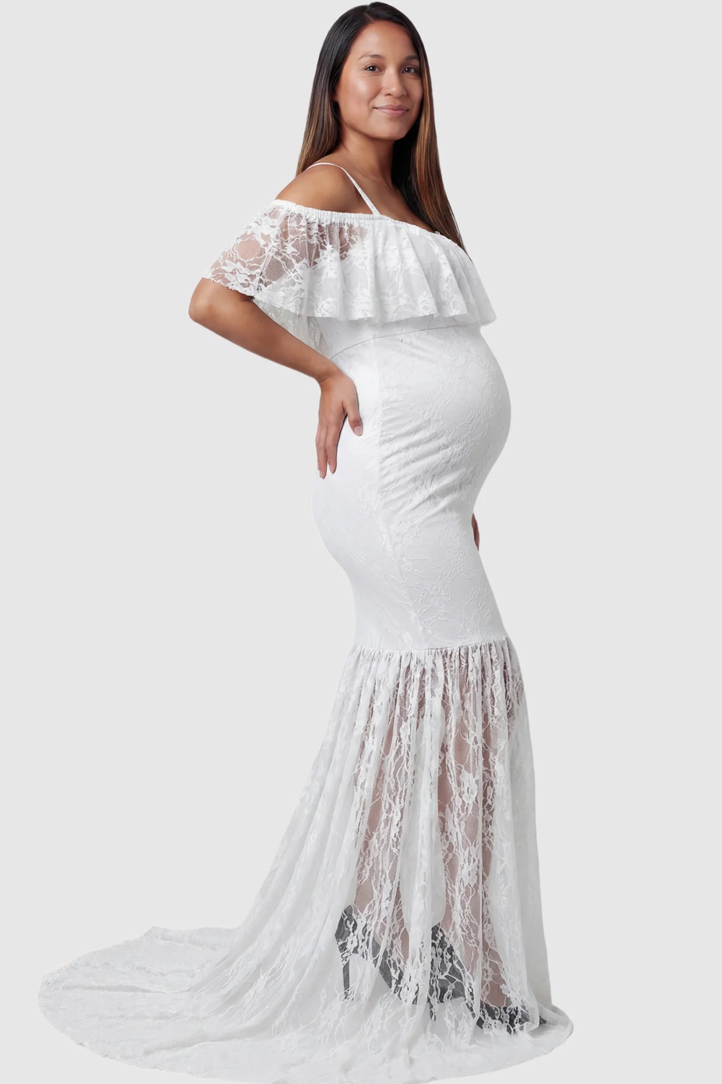 Lace Off-Shoulder Ruffle Short Sleeve Maternity Dress Lace off-shoulder maternity gown in white featuring ruffle neckline, mermaid silhouette, and extended lace train on pregnant model. side view