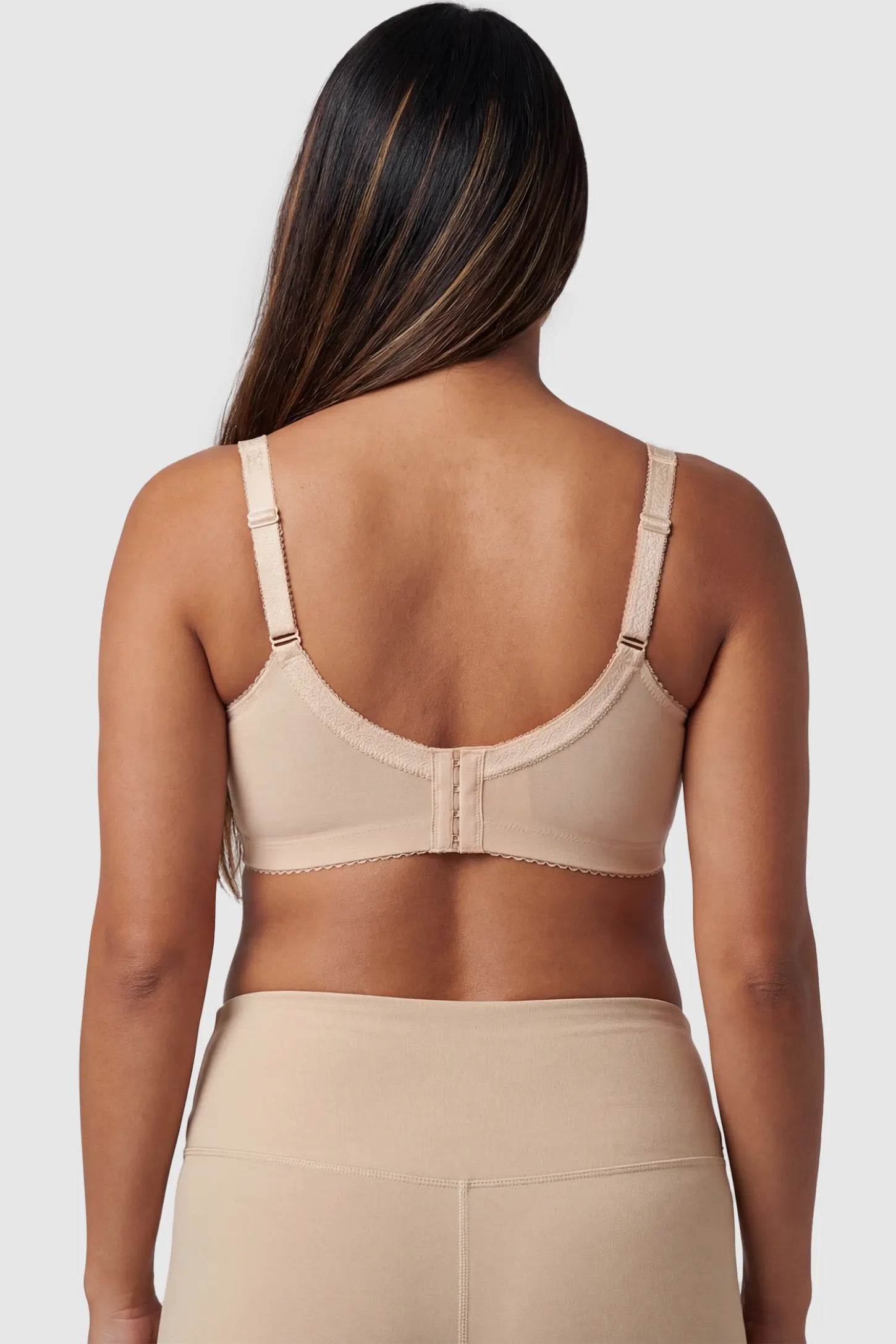 Wireless Lace Maternity Nursing Bra in beige featuring adjustable straps on pregnant model.