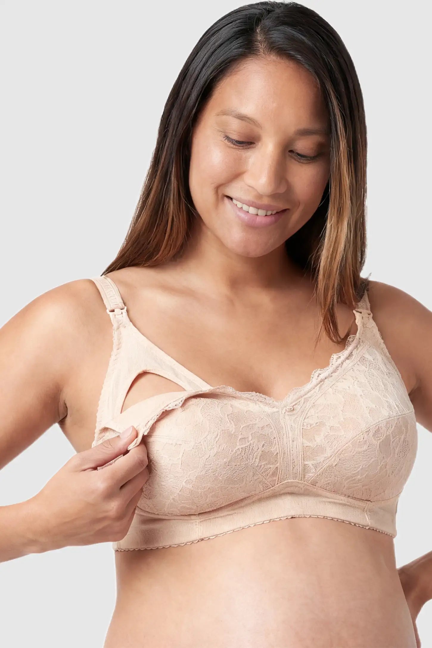 Wireless Lace Maternity Nursing Bra Wireless Lace Maternity Nursing Bra in beige featuring scalloped lace neckline, full-cup coverage, and drop-down cups on pregnant model.