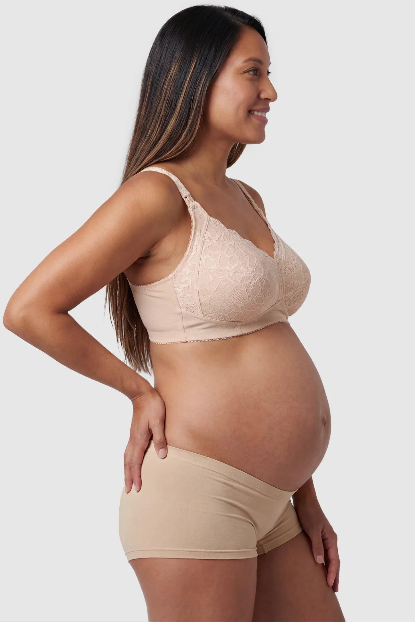 Wireless Lace Maternity Nursing Bra Wireless Lace Maternity Nursing Bra in beige featuring scalloped lace neckline, and full-cup coverage on pregnant model.