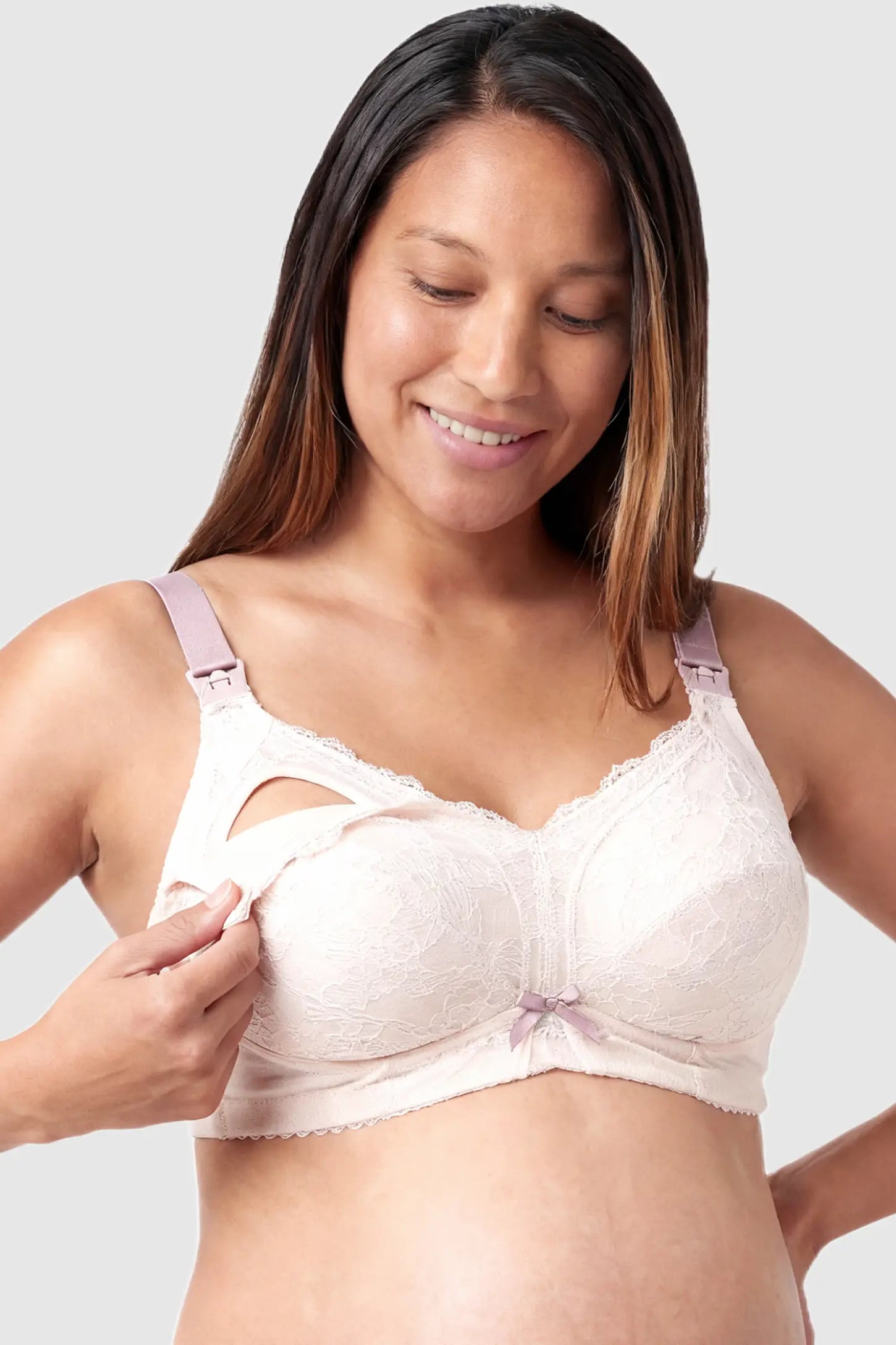 Wireless Lace Maternity Nursing Bra Wireless Lace Maternity Nursing Bra in white featuring scalloped lace neckline, full-cup coverage, and drop-down cups on pregnant model.