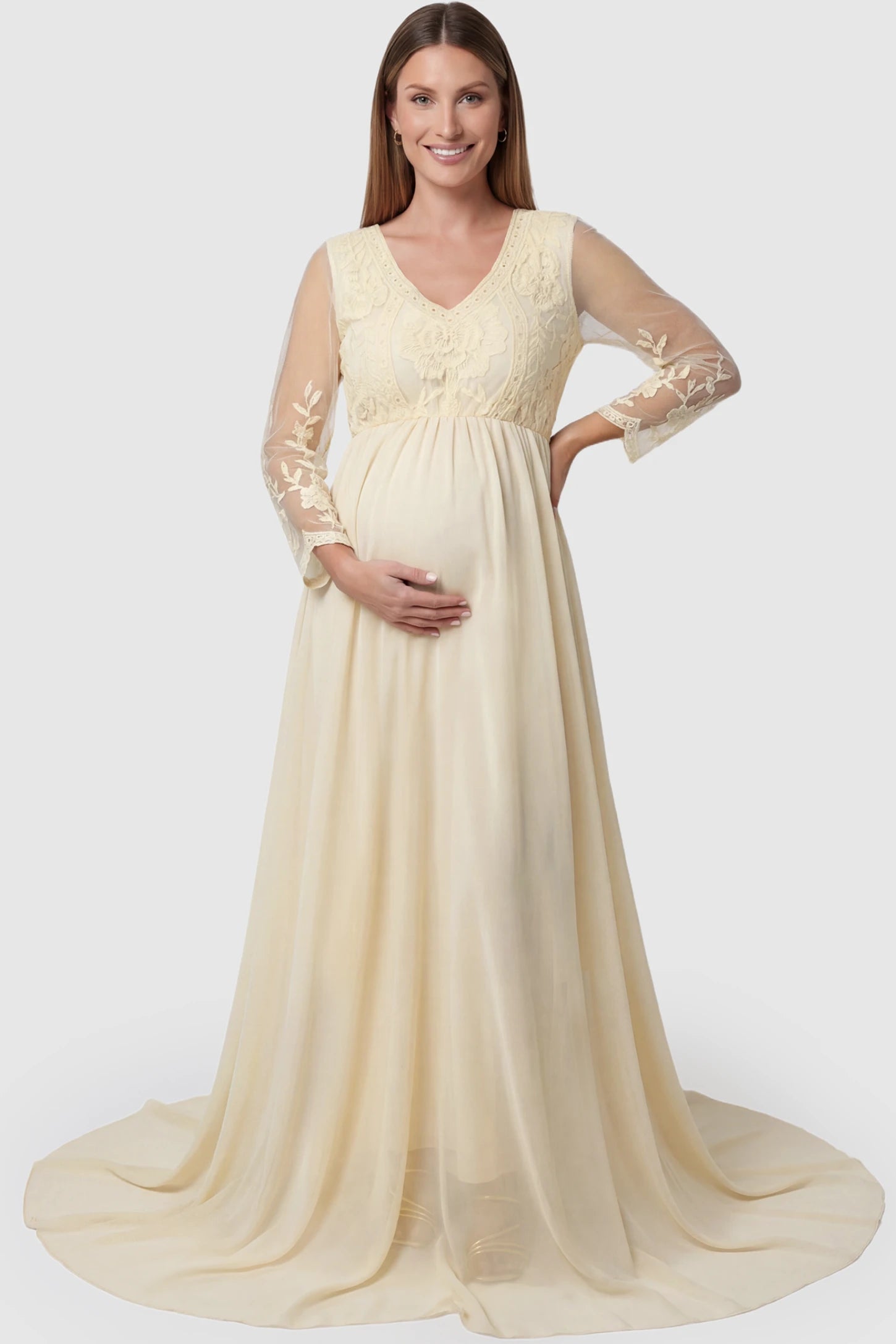 Lace Trim Long Sleeve Train Maternity Gown Lace trim long sleeve train maternity gown in apricot with flowing train silhouette & mesh sleeves, front view on pregnant model