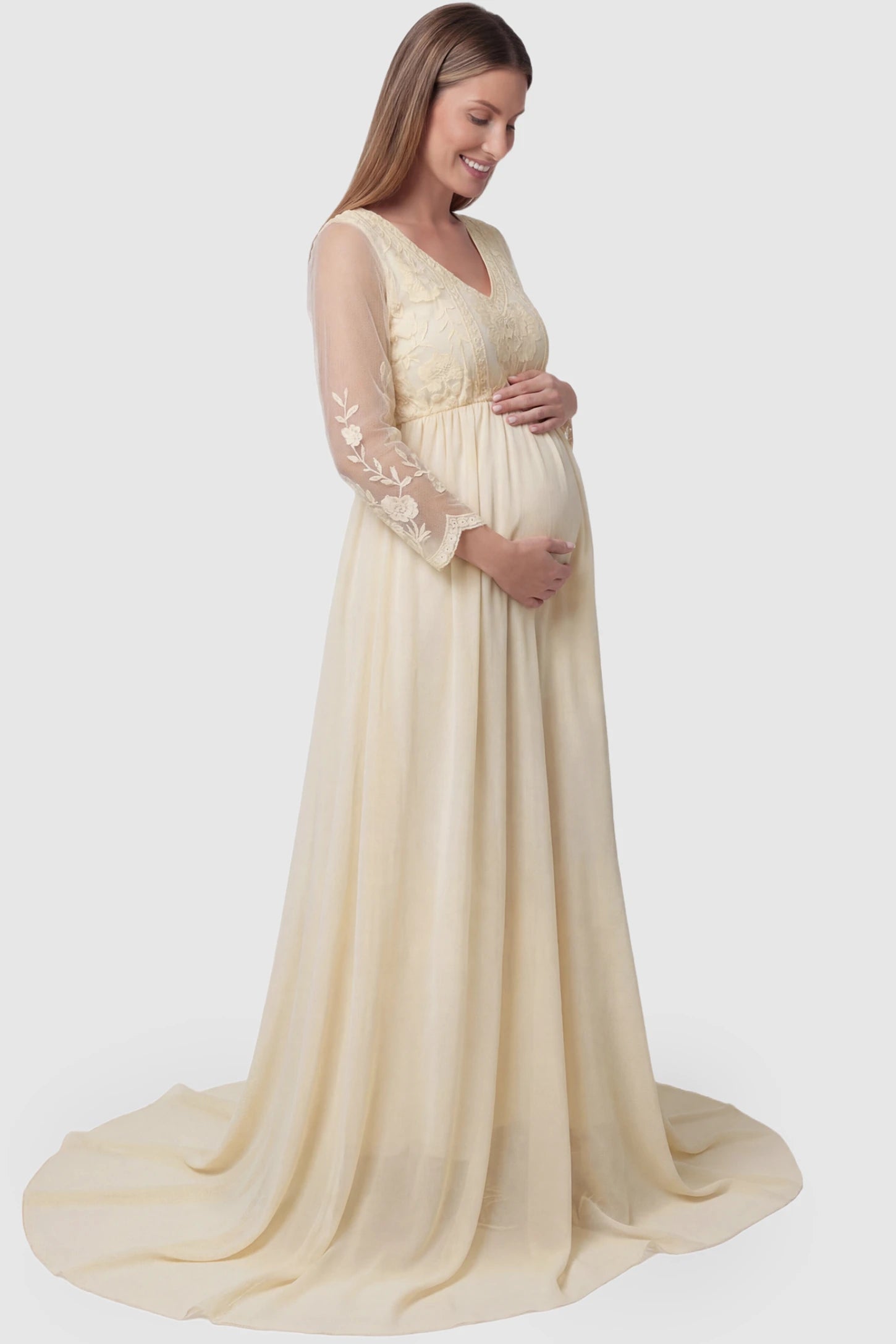 Lace Trim Long Sleeve Train Maternity Gown Lace trim long sleeve train maternity gown in apricot with flowing train silhouette & mesh sleeves, side view on pregnant model