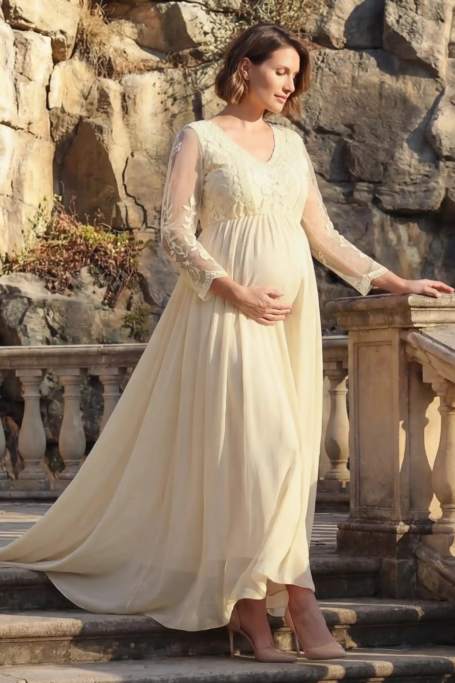 Lace Trim Long Sleeve Train Maternity Gown Lace trim long sleeve train maternity gown in apricot with flowing train silhouette & mesh sleeves, front view on pregnant model