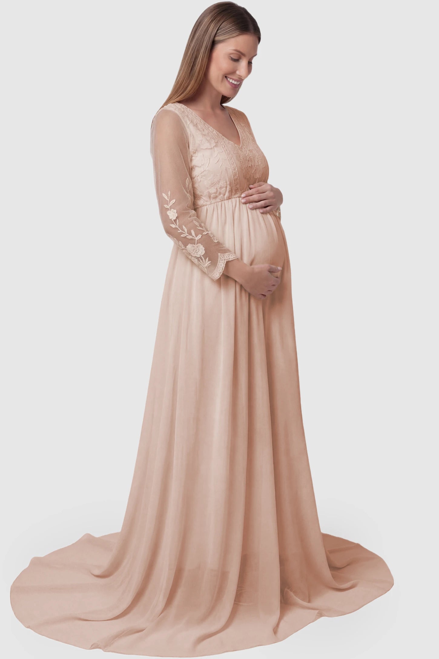 Lace Trim Long Sleeve Train Maternity Gown Lace trim long sleeve train maternity gown in pink with flowing train silhouette & mesh sleeves, side view on pregnant model