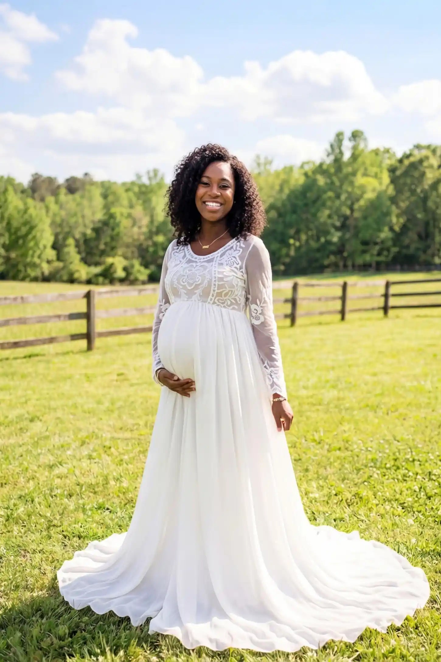 Lace trim half sleeve train maxi maternity dress in white featuring lace and mesh bodice in front view on a editorial lifestyle model