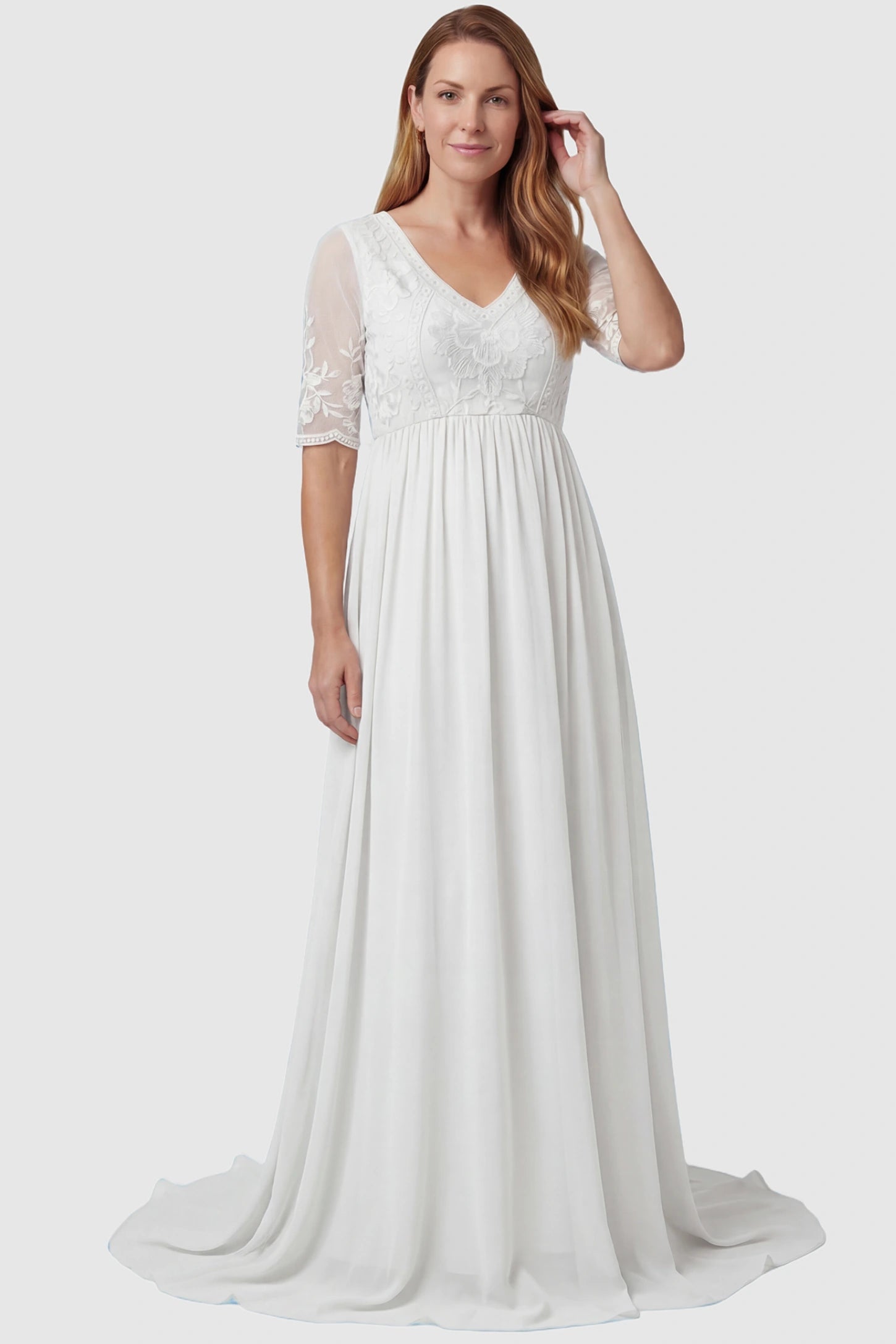 Lace Trim Long Sleeve Train Maxi Maternity Dress Lace trim half sleeve train maxi maternity dress in white featuring lace and mesh bodice in front view on a postpartum model