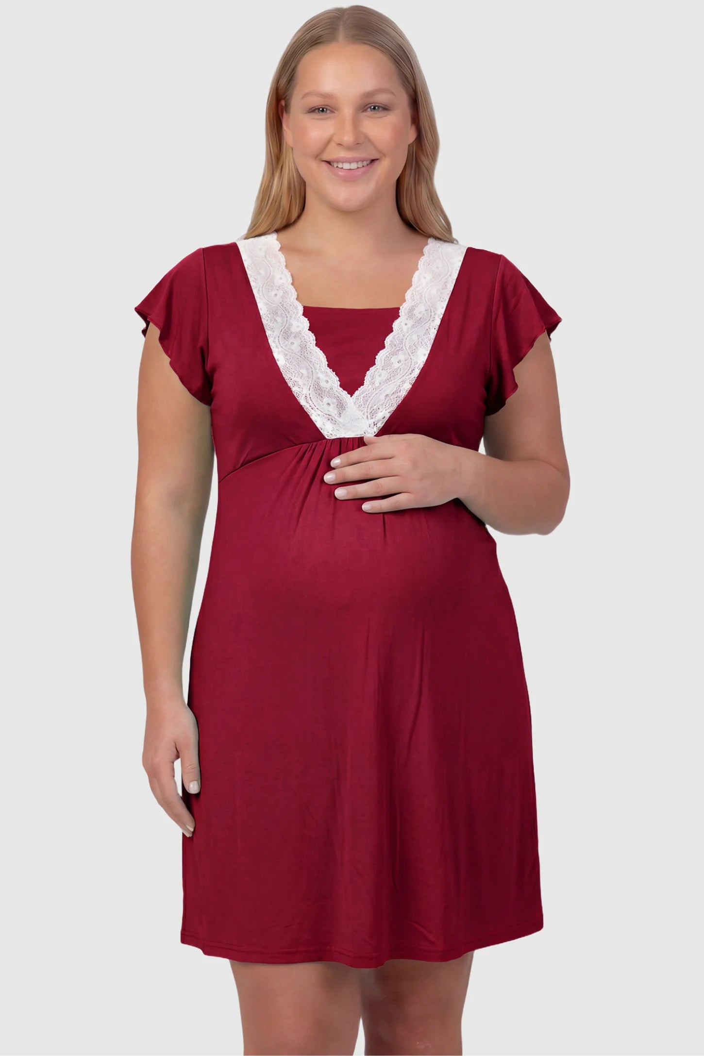 Lace Trim V-Neck Maternity & Nursing Sleep Dress Lace trim V-neck maternity nursing sleep dress in burgundy with empire waist and relaxed A-line fit on plus size pregnant model front view.