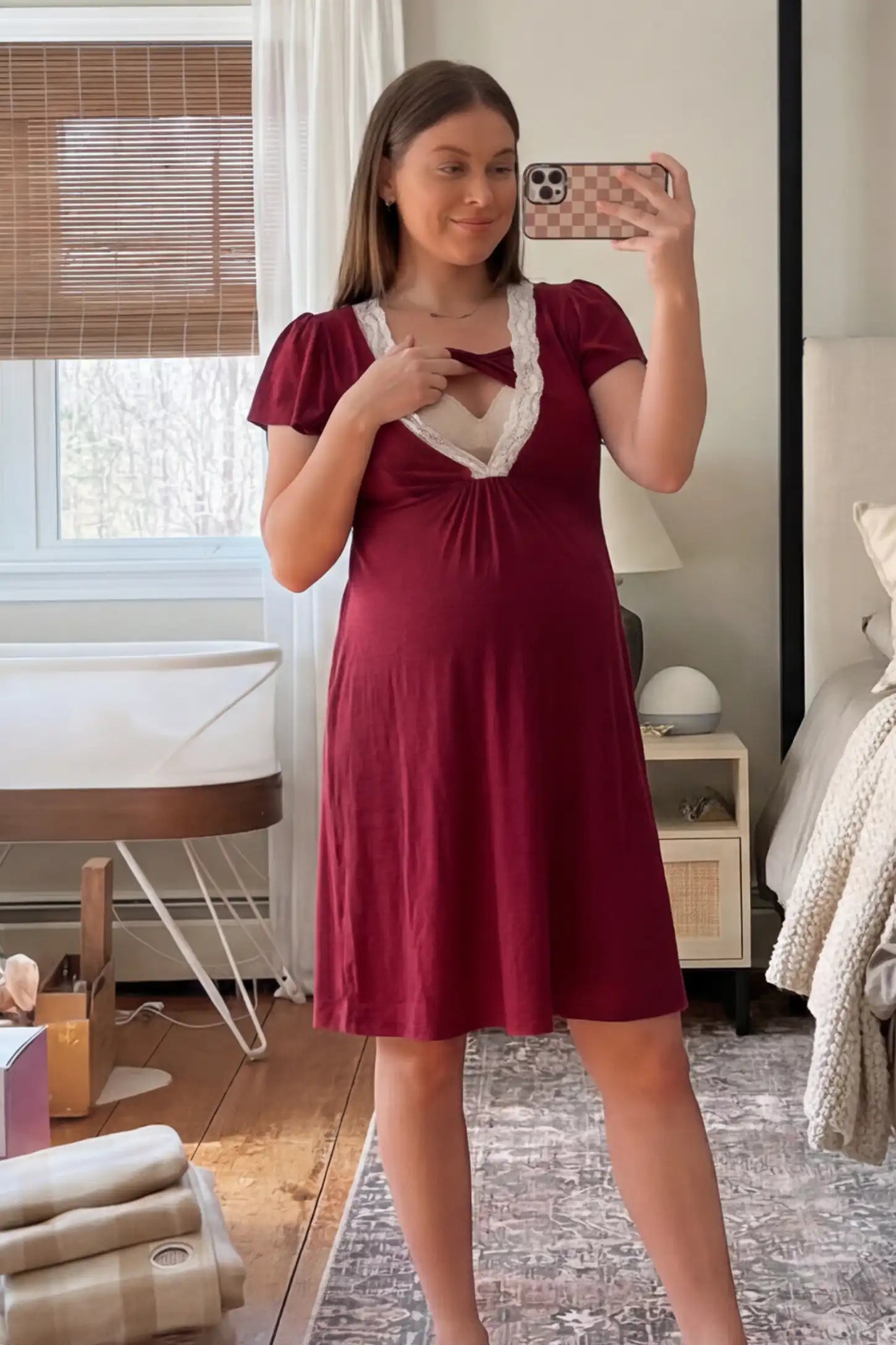 Lace Trim V-Neck Maternity & Nursing Sleep Dress Lace trim V-neck maternity nursing sleep dress in burgundy with empire waist and relaxed A-line fit on pregnant model front view.
