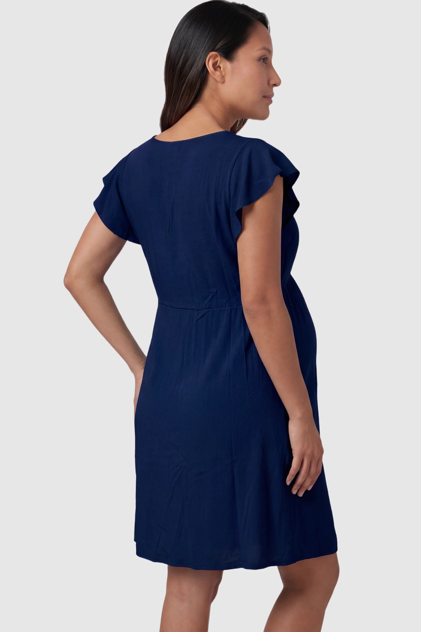 Lace Trim V-Neck Maternity & Nursing Sleep Dress Lace trim V-neck maternity nursing sleep dress in navy blue with empire waist and relaxed A-line fit on pregnant model back view.
