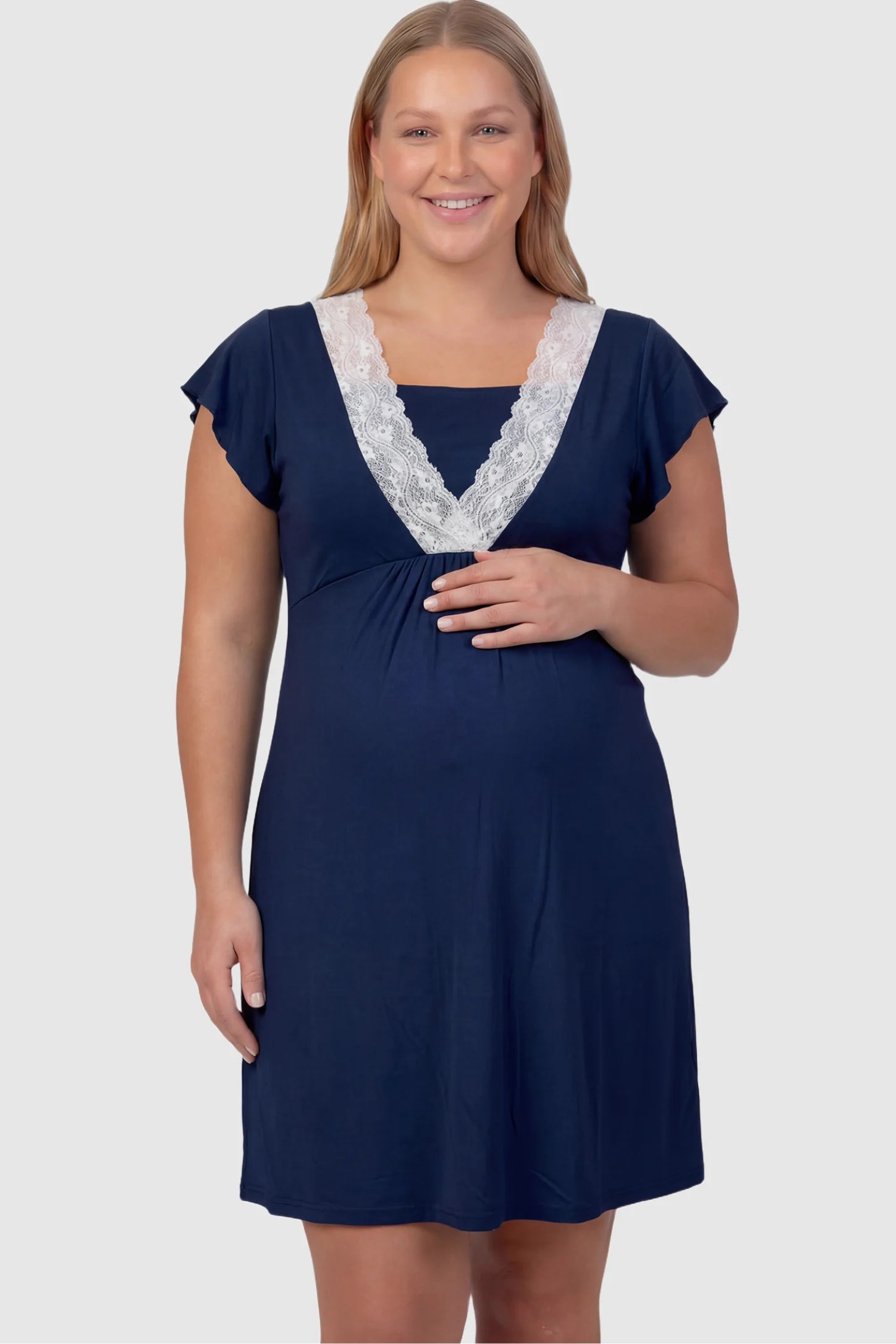 Lace Trim V-Neck Maternity & Nursing Sleep Dress Lace trim V-neck maternity nursing sleep dress in navy blue with empire waist and relaxed A-line fit on plus size pregnant model front view.