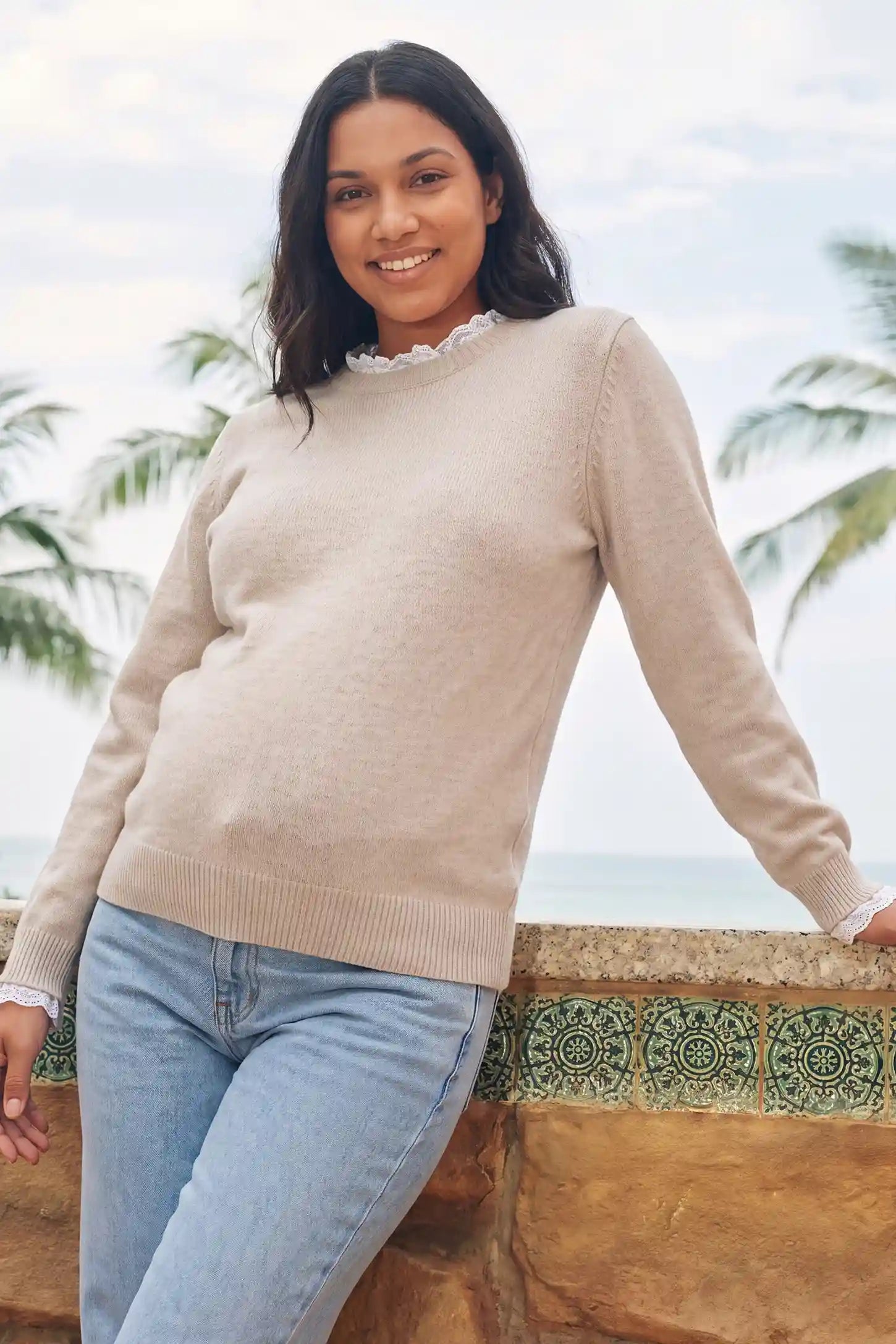 Lace-Trimmed Crewneck Maternity Knit Top Lace-Trimmed Crewneck Maternity Knit Top in Beige featuring delicate lace trim, soft stretch knit material, and gentle bump support on a pregnant model, front view.