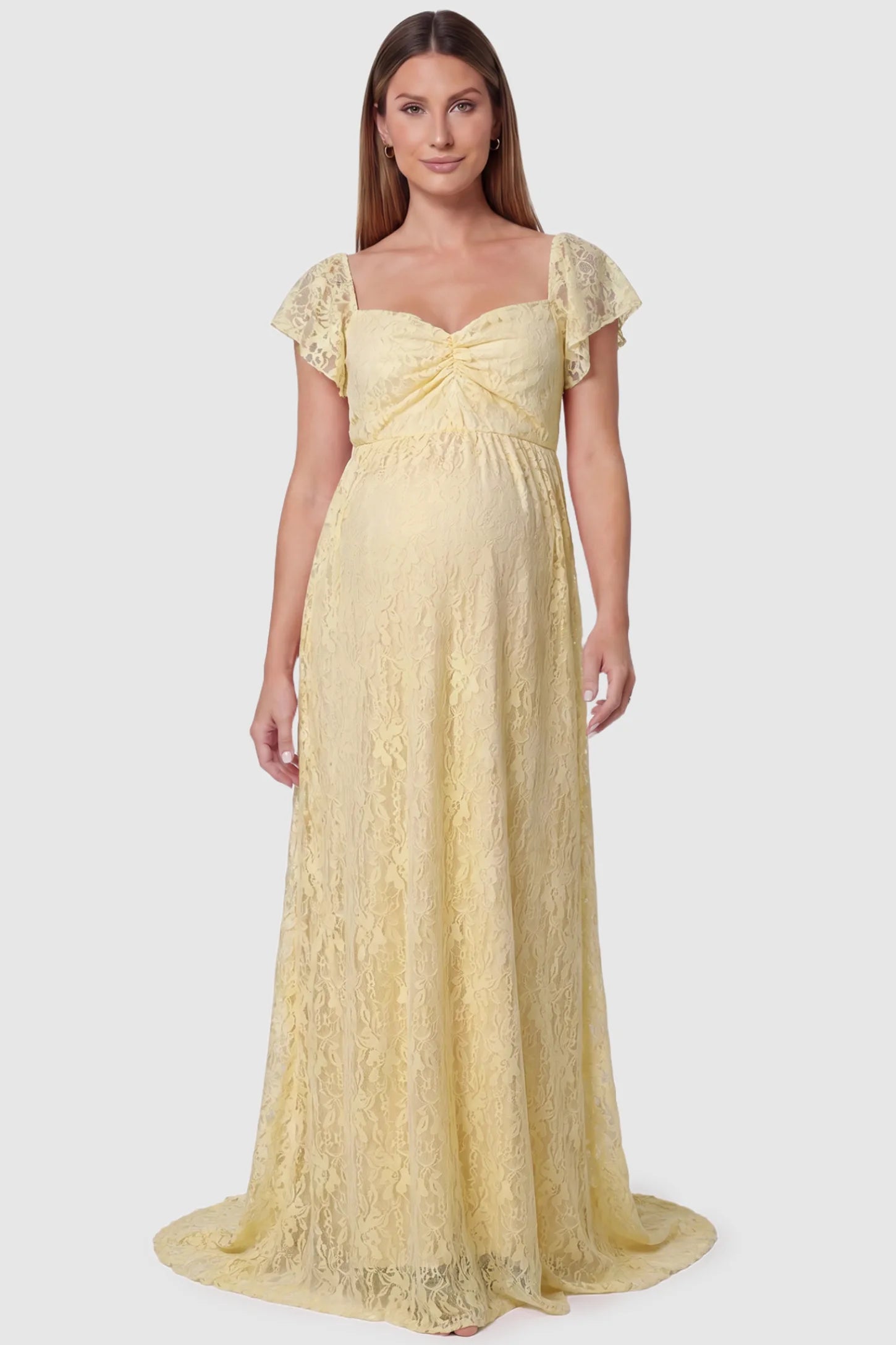 Lace Off Shoulder Maternity Maxi Dress Lace Off Shoulder Maternity Maxi Dress in apricot featuring a sweetheart neckline with a ruched bust and a full-length skirt, shown on a pregnant model, front view.