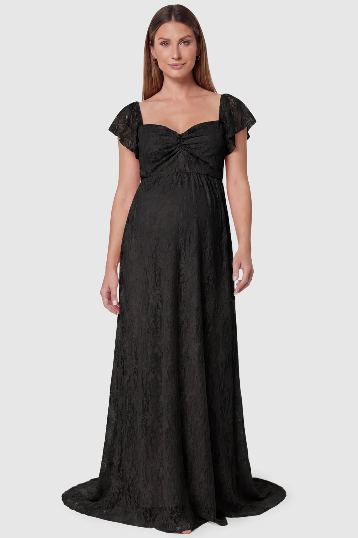 Lace Off Shoulder Maternity Maxi Dress Lace Off Shoulder Maternity Maxi Dress in black featuring a sweetheart neckline with a ruched bust and a full-length skirt, shown on a pregnant model, front view.