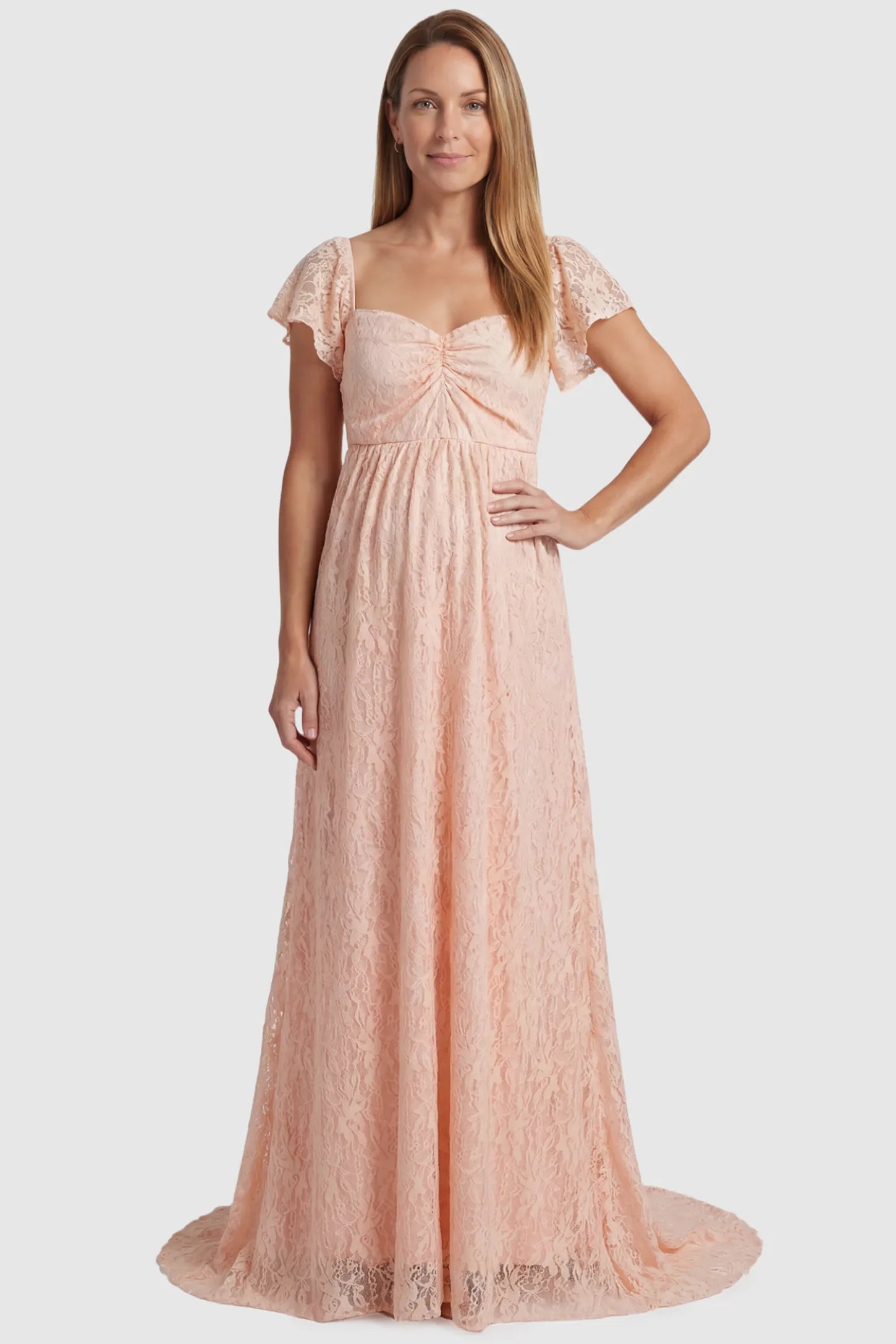 Lace Off Shoulder Maternity Maxi Dress Lace Off Shoulder Maternity Maxi Dress in blush pink featuring a sweetheart neckline with a ruched bust and a full-length skirt, shown on a postpartum model, front view.