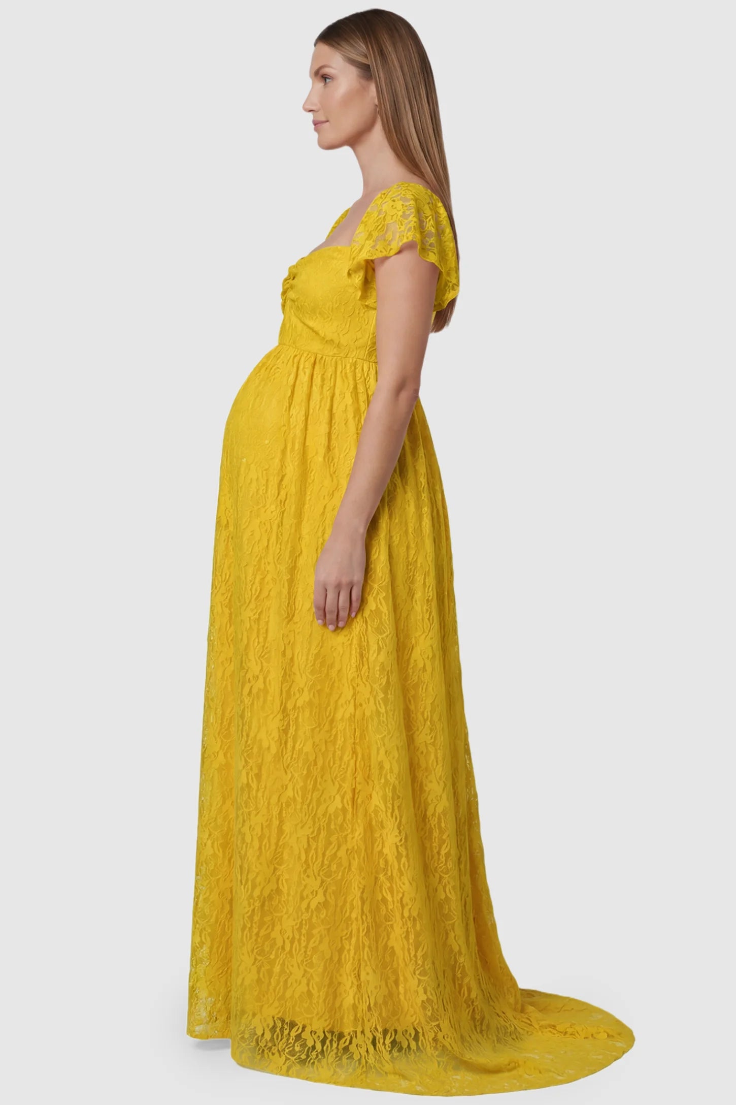 Lace Off Shoulder Maternity Maxi Dress Lace Off Shoulder Maternity Maxi Dress in ginger yellow featuring a sweetheart neckline with a ruched bust and a full-length skirt, shown on a pregnant model, side view.