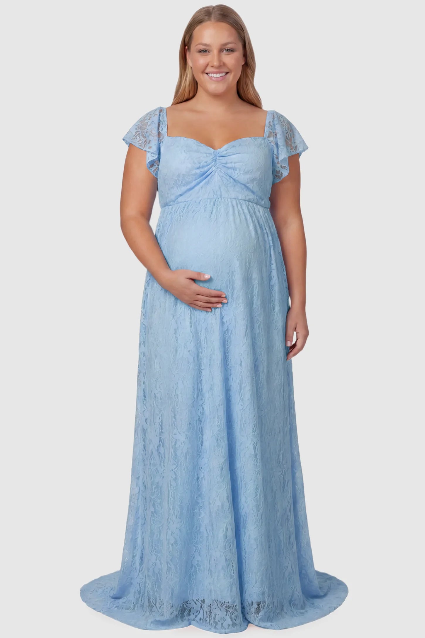 Lace Off Shoulder Maternity Maxi Dress Lace Off Shoulder Maternity Maxi Dress in light blue featuring a sweetheart neckline with a ruched bust and a full-length skirt, shown on a plus size pregnant model, front view.