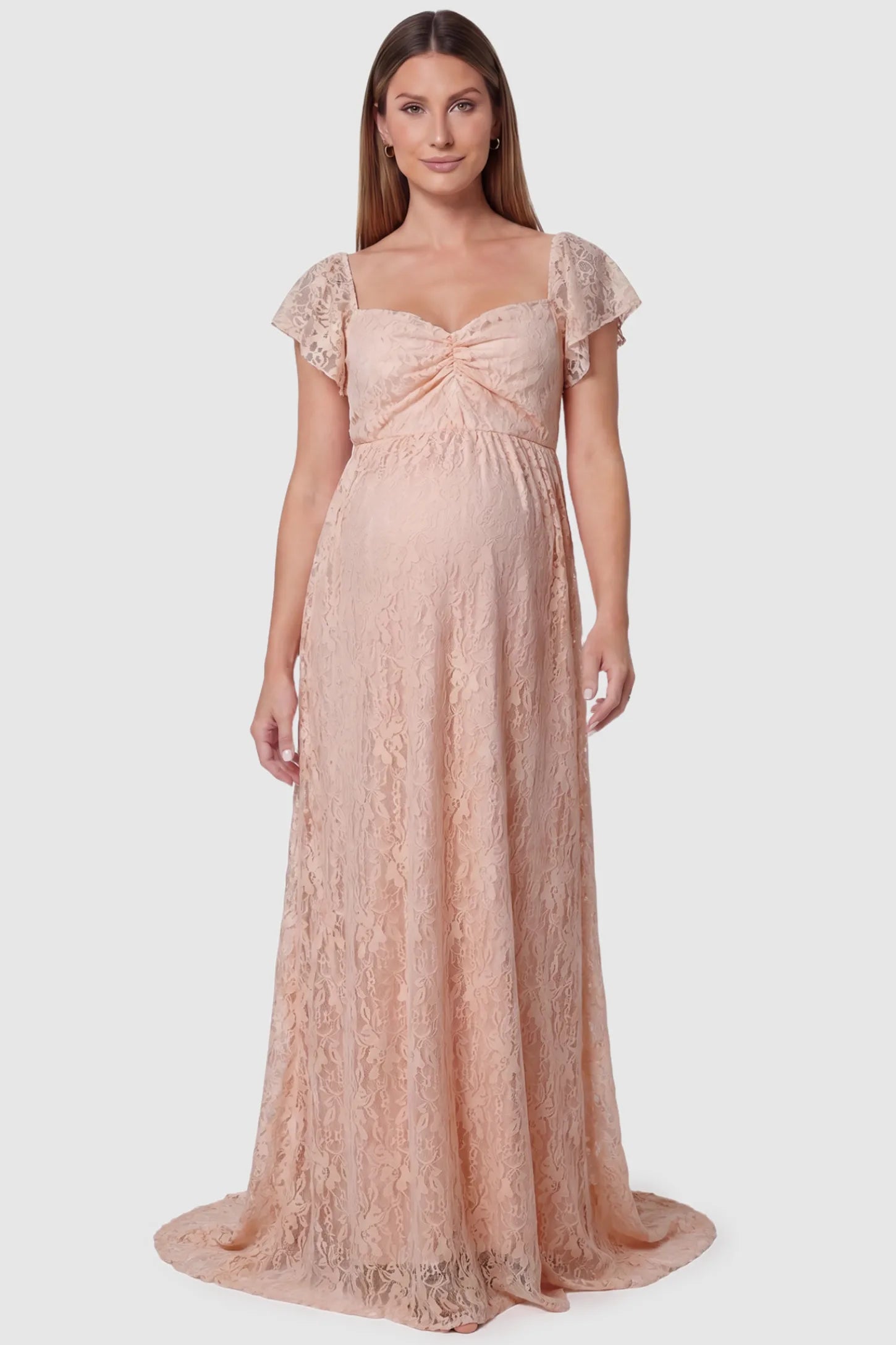 Lace Off Shoulder Maternity Maxi Dress Lace Off Shoulder Maternity Maxi Dress in pink featuring a sweetheart neckline with a ruched bust and a full-length skirt, shown on a pregnant model, front view.
