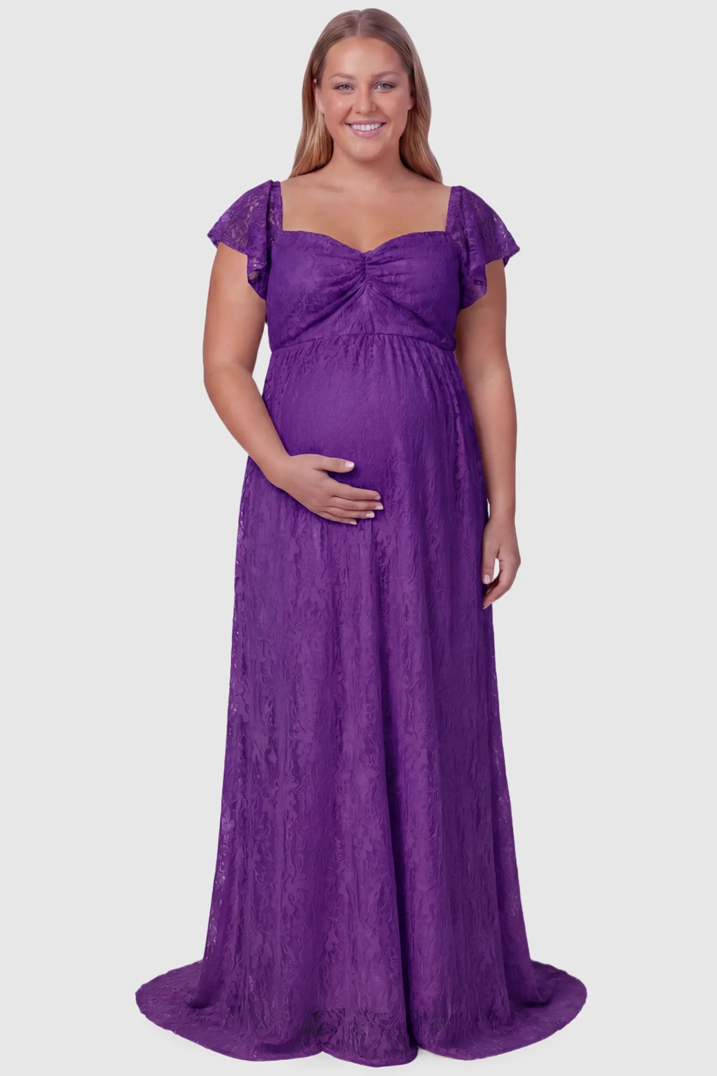 Lace Off Shoulder Maternity Maxi Dress Lace Off Shoulder Maternity Maxi Dress in purple featuring a sweetheart neckline with a ruched bust and a full-length skirt, shown on a plus size pregnant model, front view.