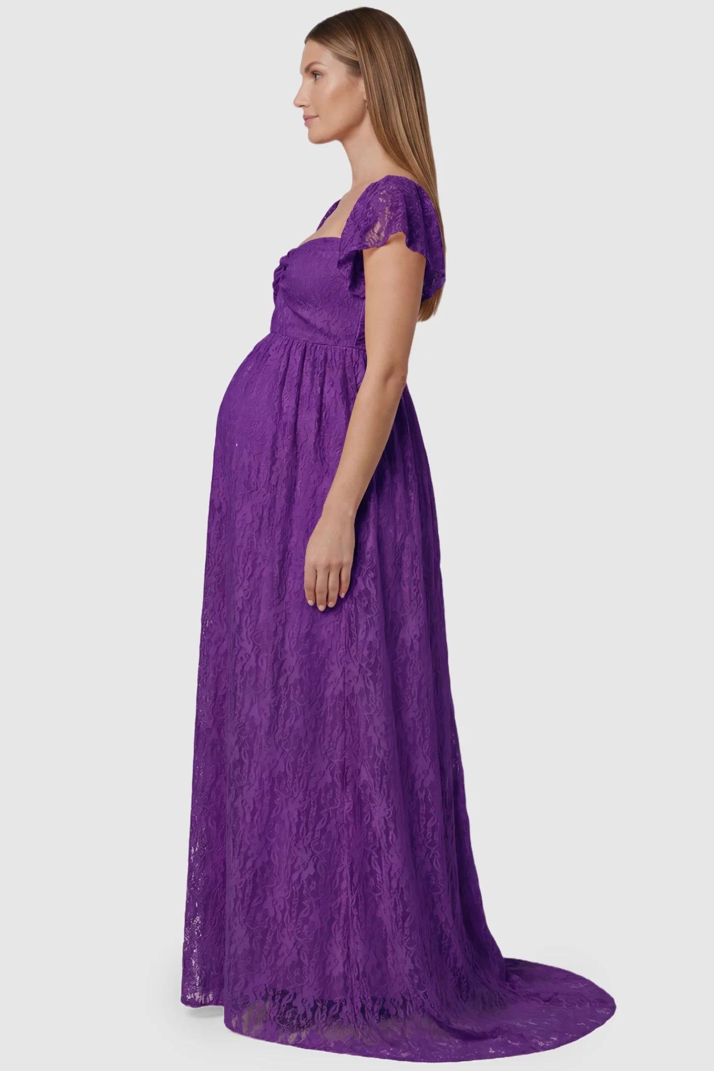 Lace Off Shoulder Maternity Maxi Dress Lace Off Shoulder Maternity Maxi Dress in purple featuring a sweetheart neckline with a ruched bust and a full-length skirt, shown on a pregnant model, side view.