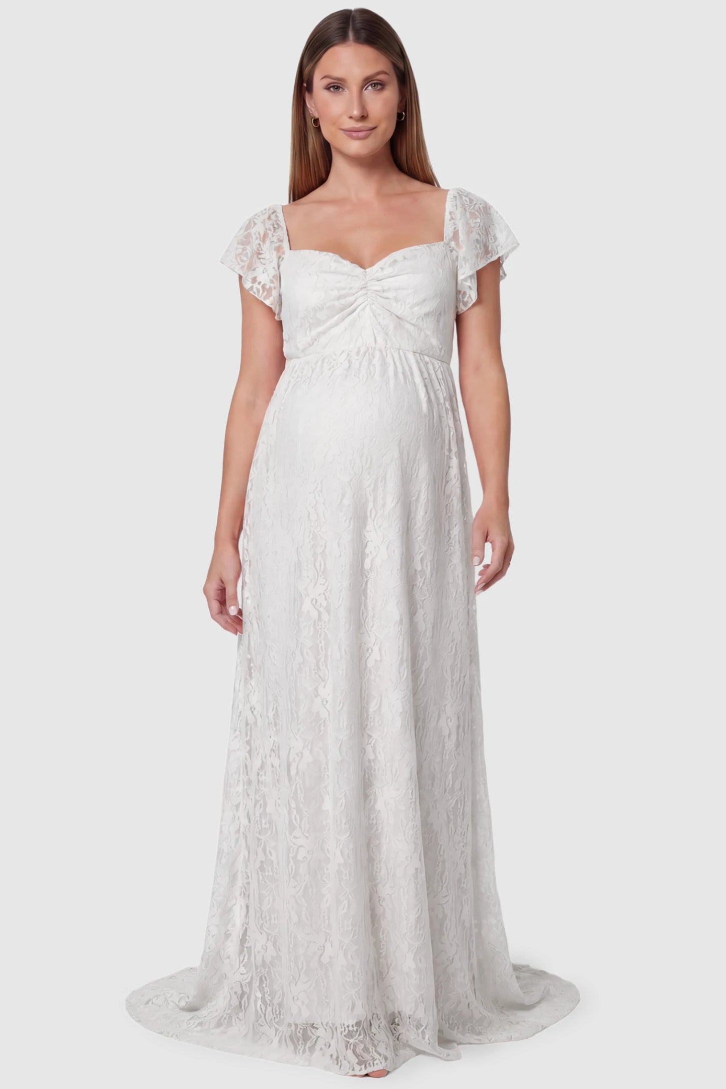 Lace Off Shoulder Maternity Maxi Dress Lace Off Shoulder Maternity Maxi Dress in white featuring a sweetheart neckline with a ruched bust and a full-length skirt, shown on a pregnant model, front view.