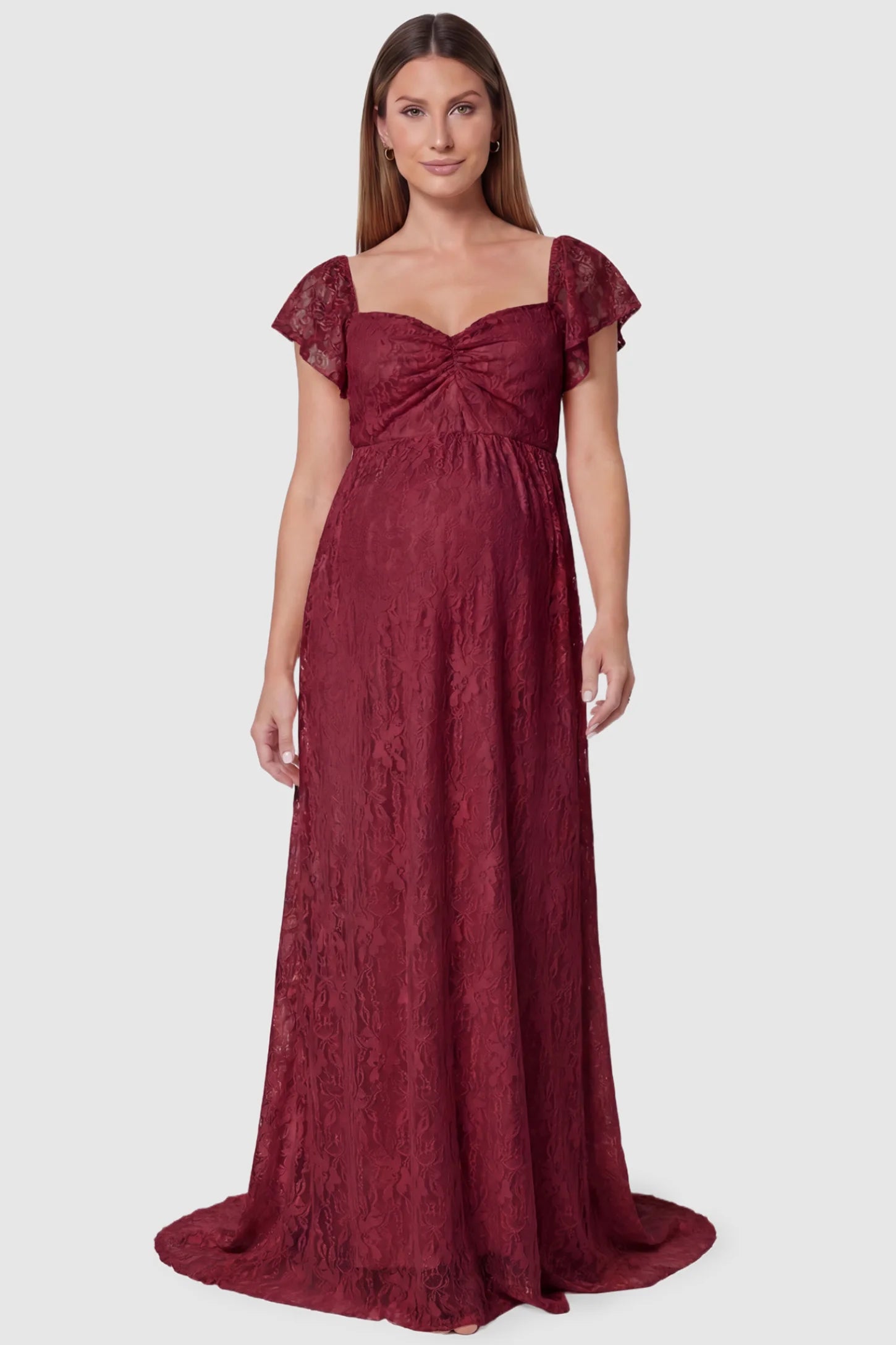 Lace Off Shoulder Maternity Maxi Dress Lace Off Shoulder Maternity Maxi Dress in wine red featuring a sweetheart neckline with a ruched bust and a full-length skirt, shown on a pregnant model, front view.