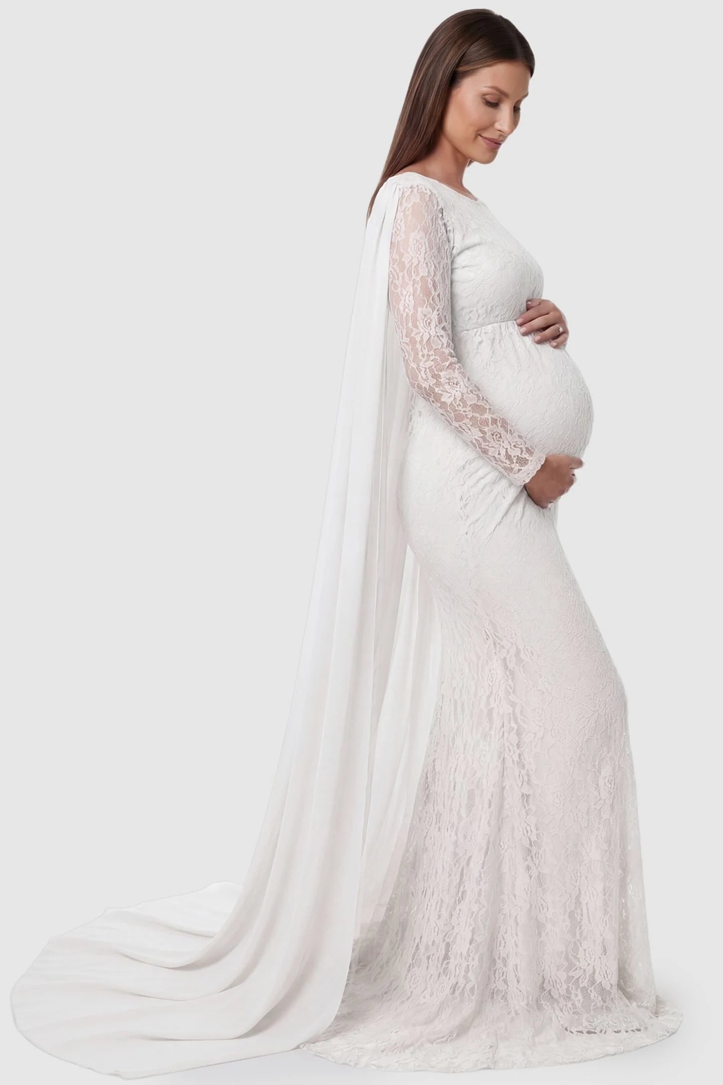 Lace & Chiffon Spliced Long Sleeve Maternity Photoshoot Gown Lace & Chiffon Spliced Maternity Photoshoot Gown in White featuring a slim fit lace skirt on a pregnant model side view.