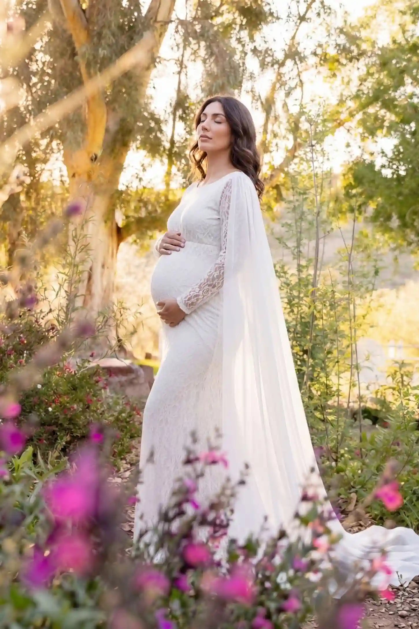 Lace & Chiffon Spliced Long Sleeve Maternity Photoshoot Gown Lace & Chiffon Spliced Maternity Photoshoot Gown in White featuring a slim fit lace skirt on a pregnant model side view.
