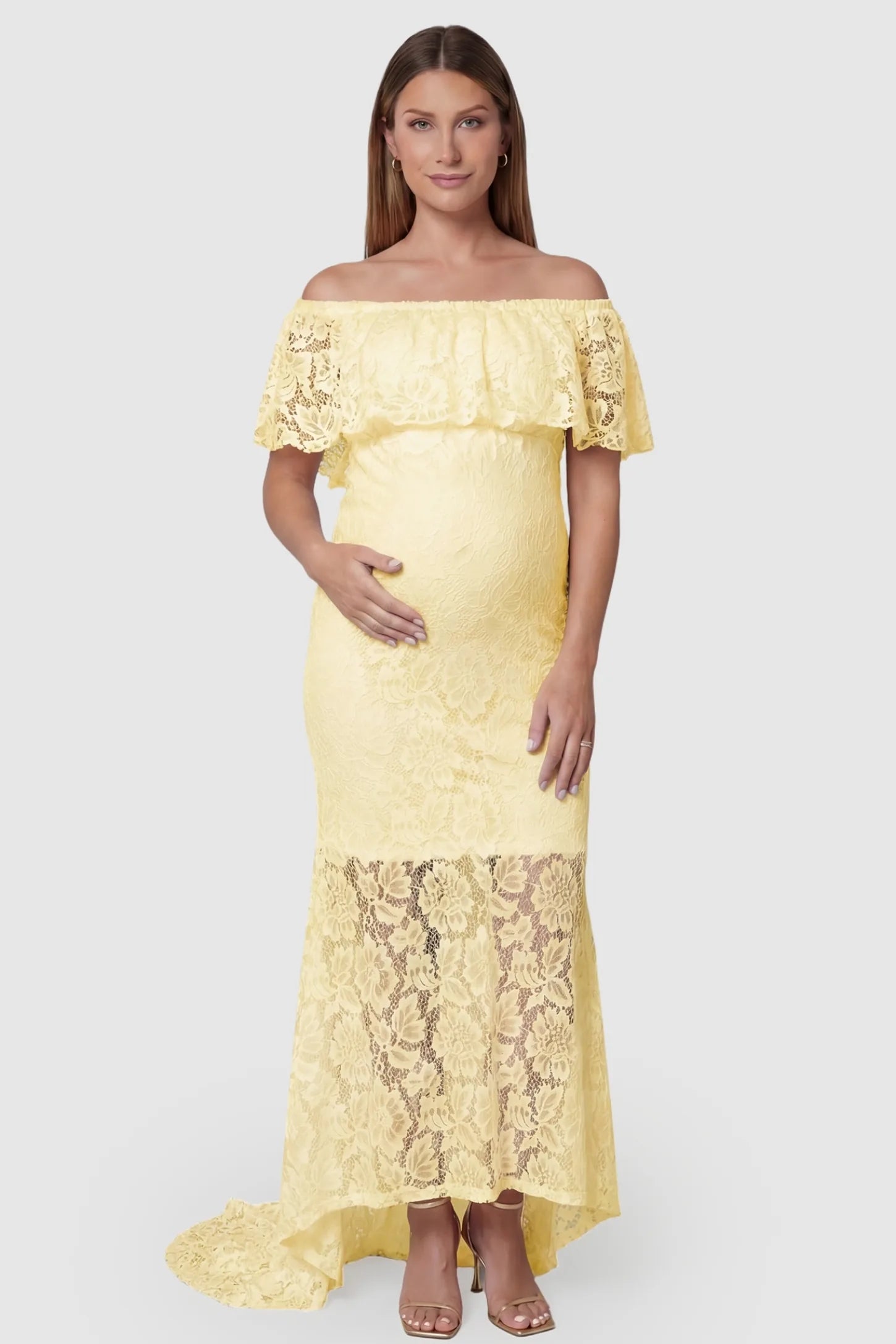 Lace Off-the-Shoulder Flutter Sleeve Maternity Maxi Dress Lace Off-the-Shoulder Flutter Sleeve Maternity Dress in Beige featuring a ruffled neckline on a front-facing pregnant model.