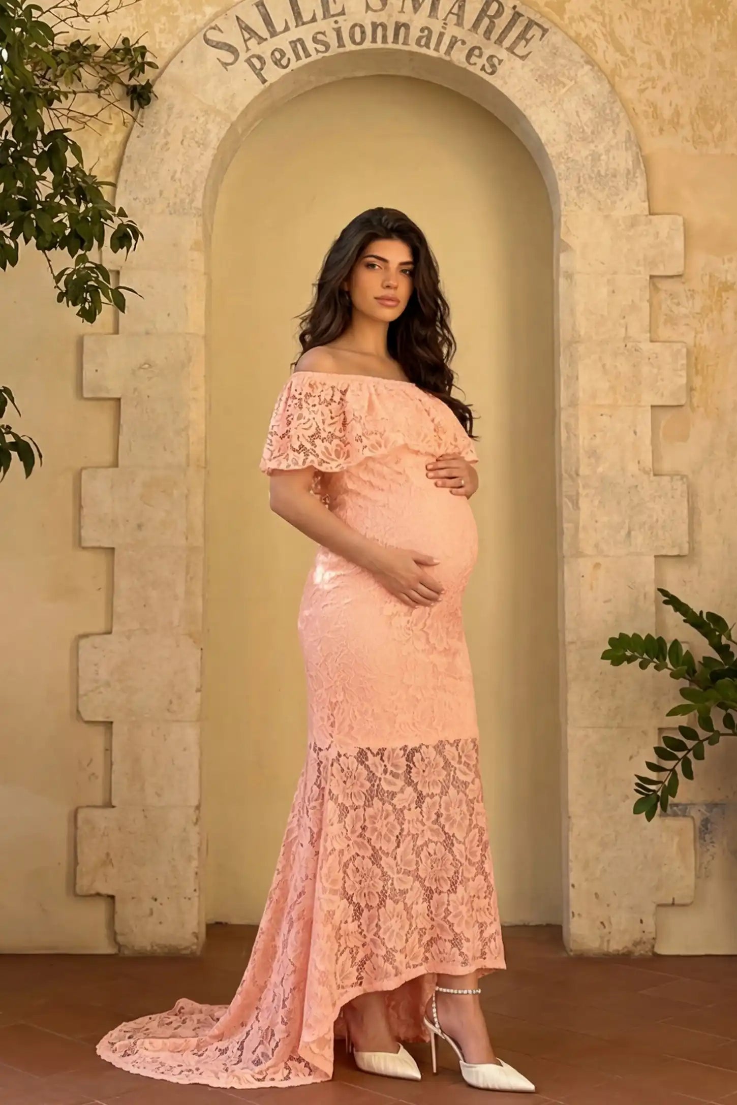 Lace Off-the-Shoulder Flutter Sleeve Maternity Maxi Dress Lace Off-the-Shoulder Flutter Sleeve Maternity Dress in Pink featuring a scalloped lace edge on a side-view pregnant model.