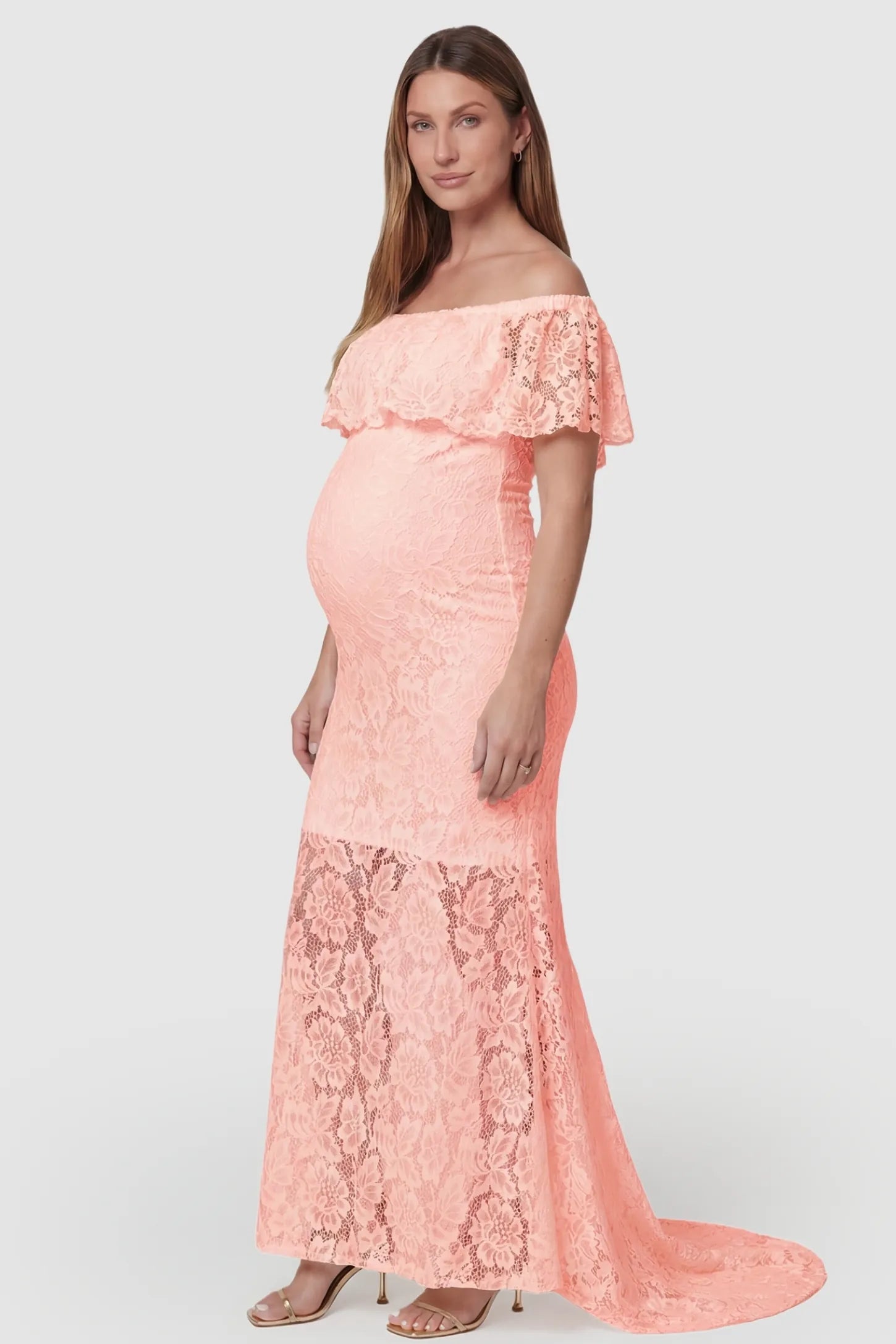 Lace Off-the-Shoulder Flutter Sleeve Maternity Maxi Dress Lace Off-the-Shoulder Flutter Sleeve Maternity Dress in Pink featuring a scalloped lace edge on a side-view pregnant model.