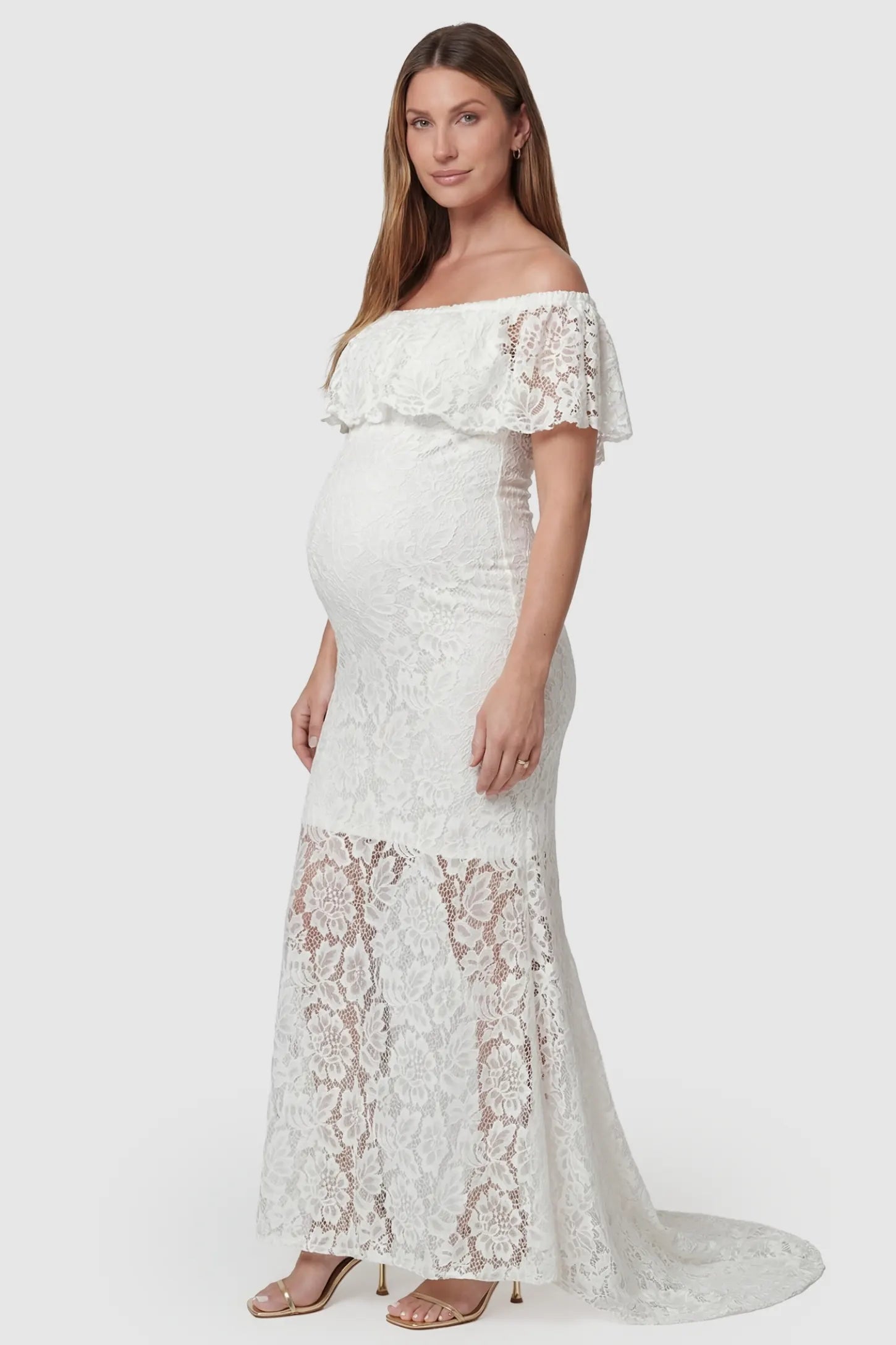 Lace Off-the-Shoulder Flutter Sleeve Maternity Maxi Dress Lace Off-the-Shoulder Flutter Sleeve Maternity Dress in White featuring a sheer lace skirt detail on a side-view pregnant model.