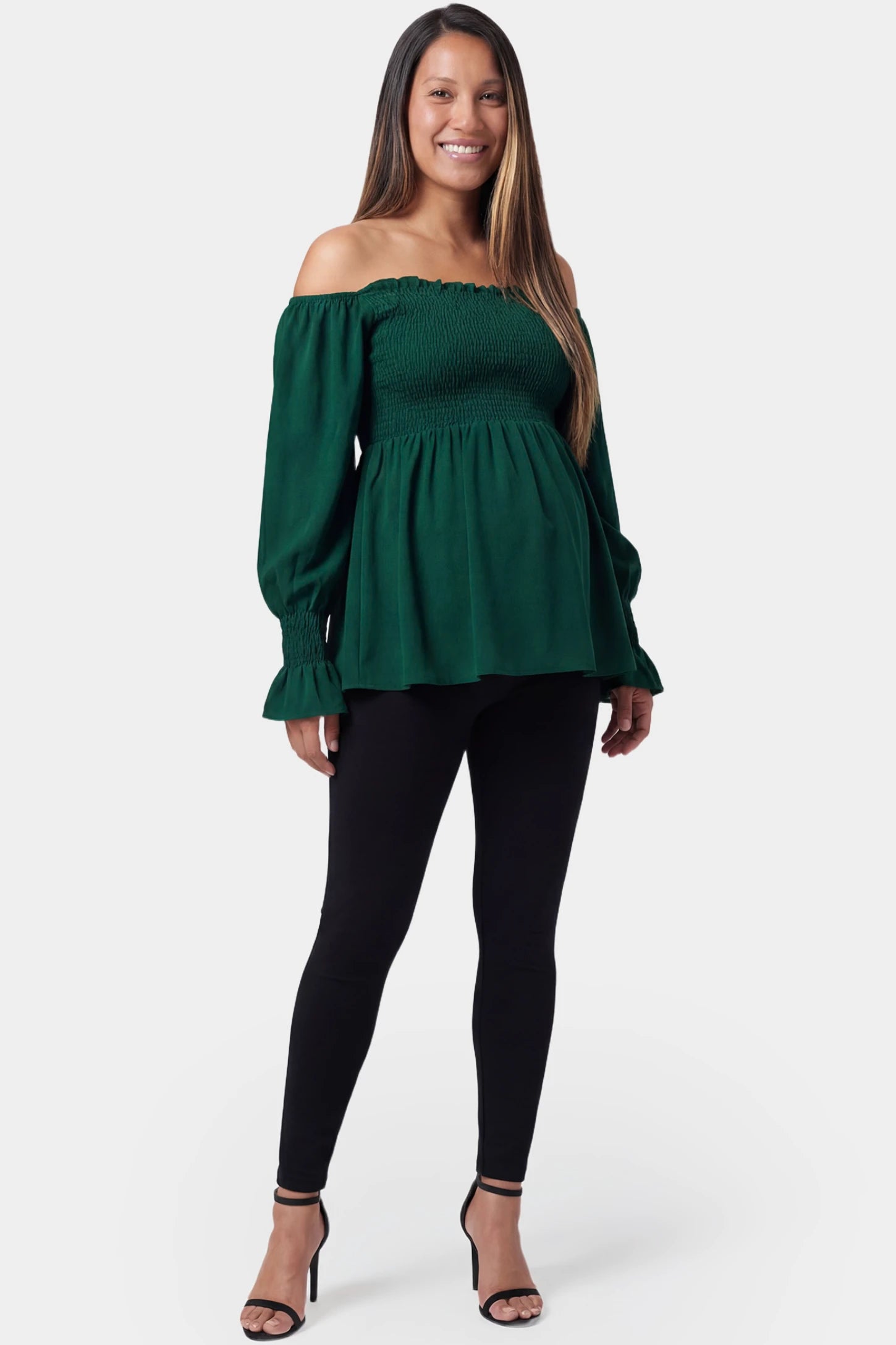 Smocked Lantern Sleeve Maternity Top Smocked lantern sleeve maternity top in emerald green featuring off shoulder neckline in full body view on a pregnant model