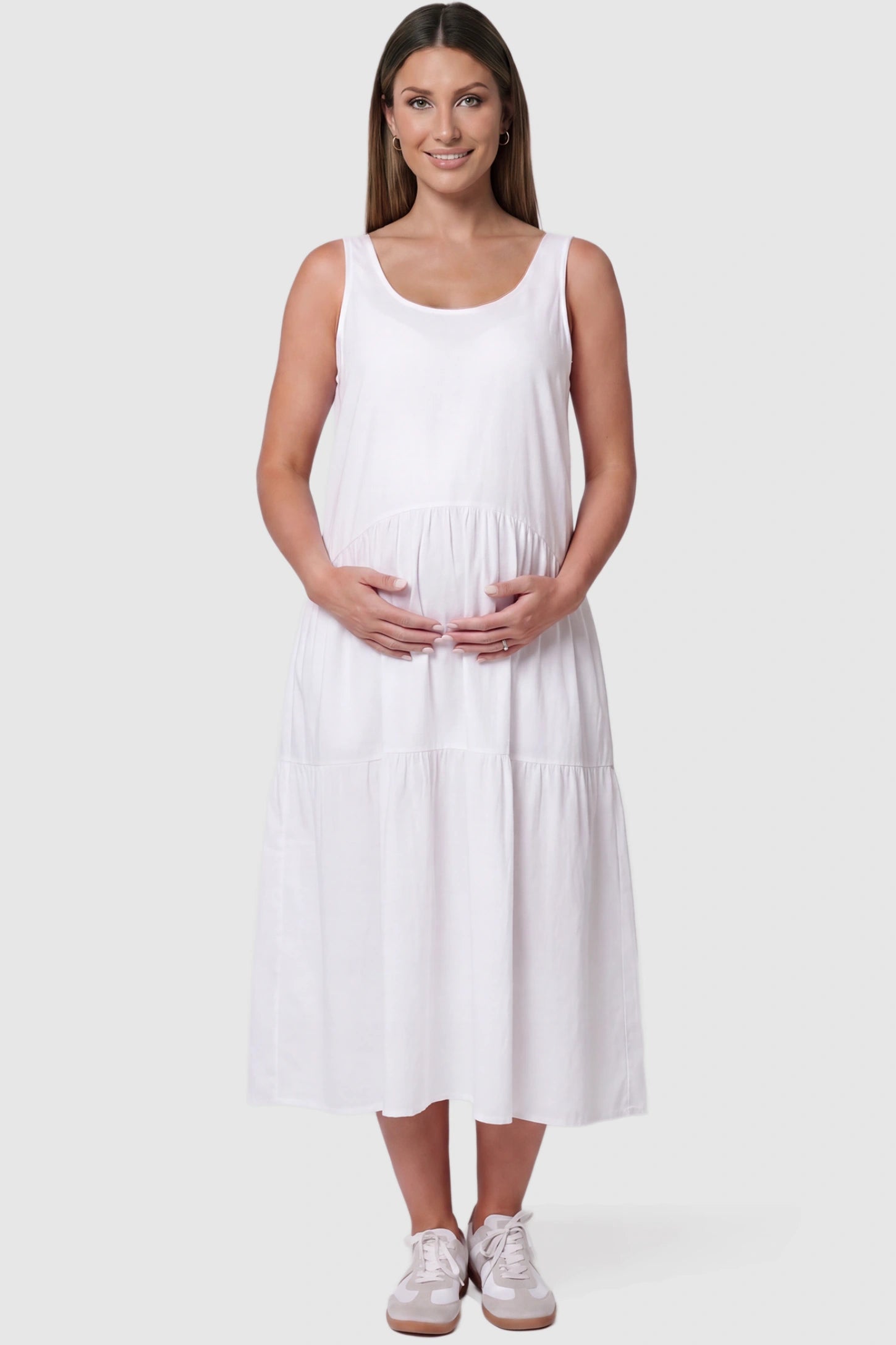 Layered skirt A-line maternity midi dress in white with sleeveless design, front view on pregnant model