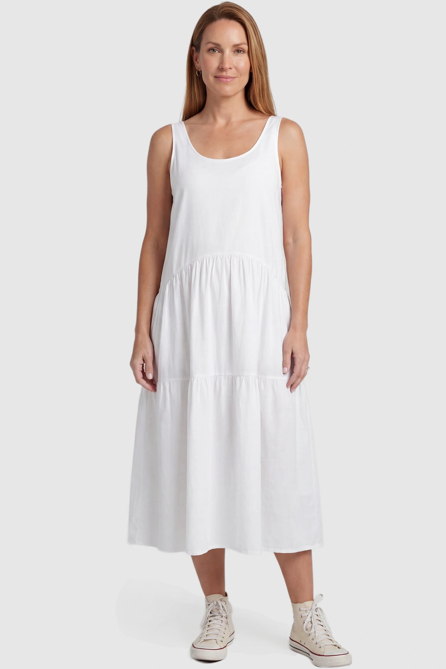 Layered Skirt A-Line Maternity Midi Dress Layered skirt A-line maternity midi dress in white with sleeveless design, front view on postpartum model