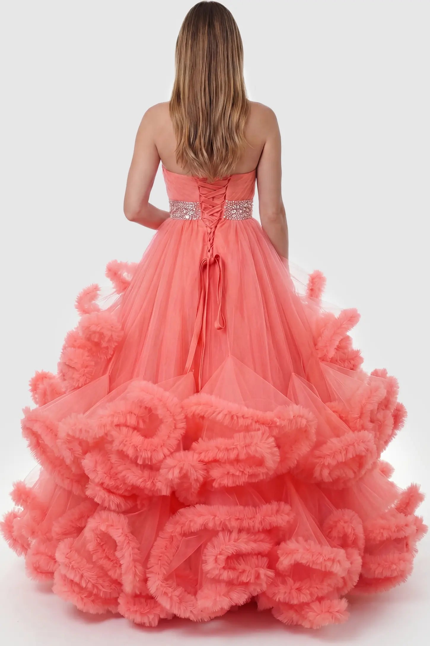 Multi-Layered Pleated Tulle Strapless Bodice Maxi Maternity Gown Multi-layered pleated tulle strapless bodice maxi maternity gown in orange featuring elegant ruffled hem in back view on a pregnant model