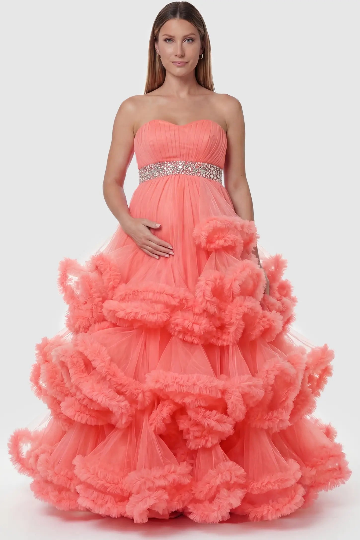 Multi-Layered Pleated Tulle Strapless Bodice Maxi Maternity Gown Multi-layered pleated tulle strapless bodice maxi maternity gown in orange featuring structured strapless bodice in front view on a pregnant model