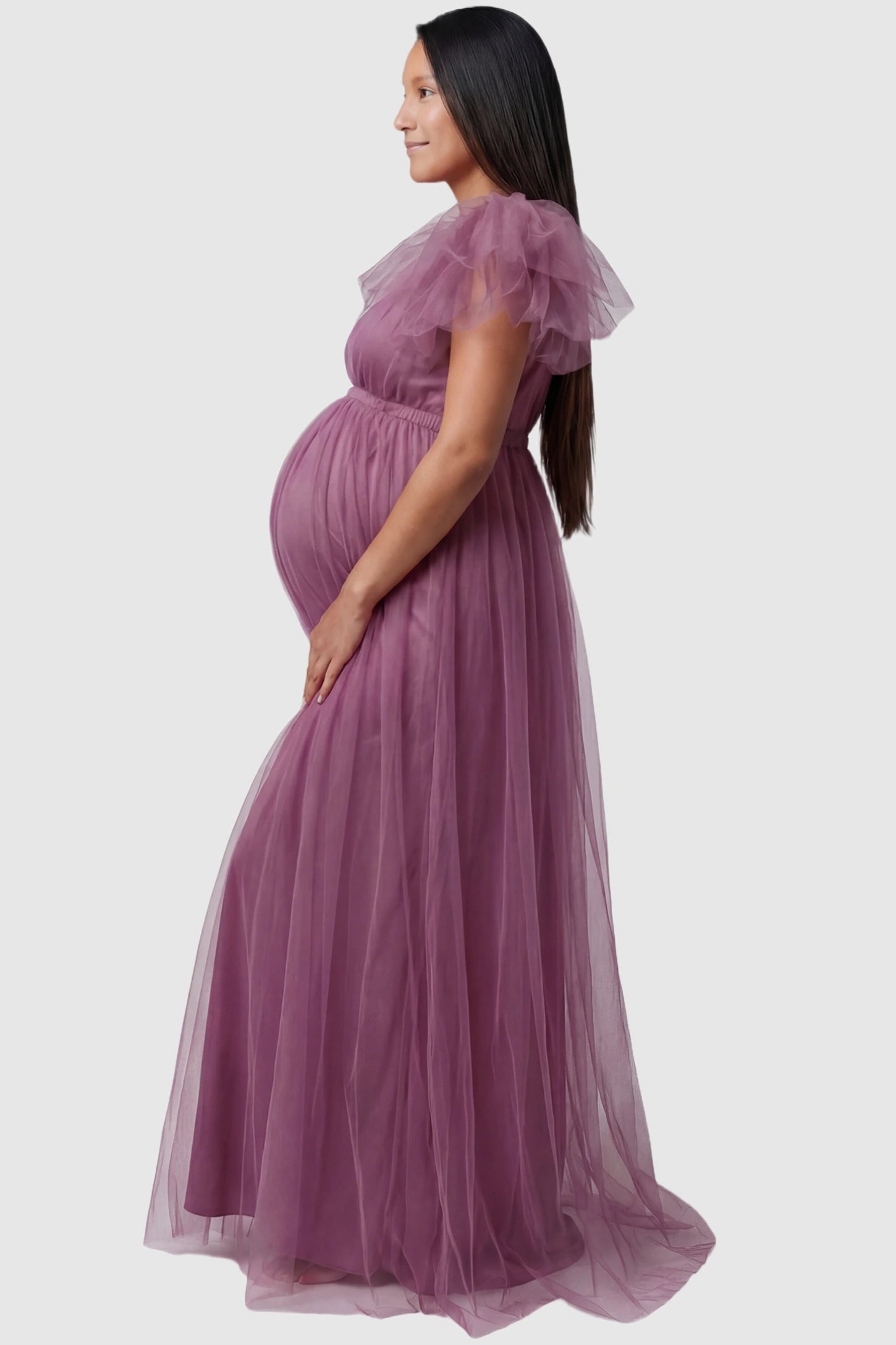 Layered Tulle Ruffle Sleeve Maternity Photoshoot Dress Layered Tulle Ruffle Sleeve Maternity Photoshoot Dress in Mauve featuring a ruffled sleeve profile on a pregnant model.