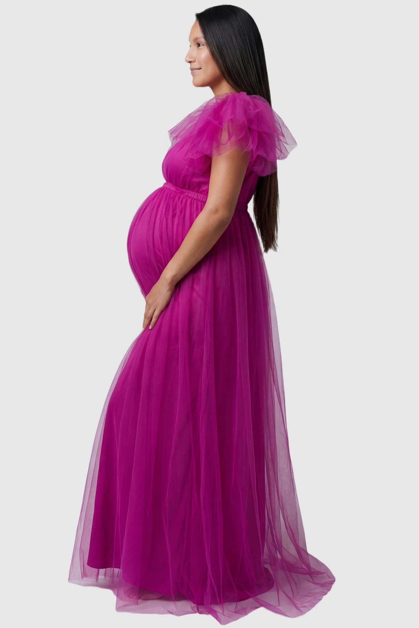 Layered Tulle Ruffle Sleeve Maternity Photoshoot Dress Layered Tulle Ruffle Sleeve Maternity Photoshoot Dress in Rose Red featuring a side view of the ruffled sleeves on a pregnant model.